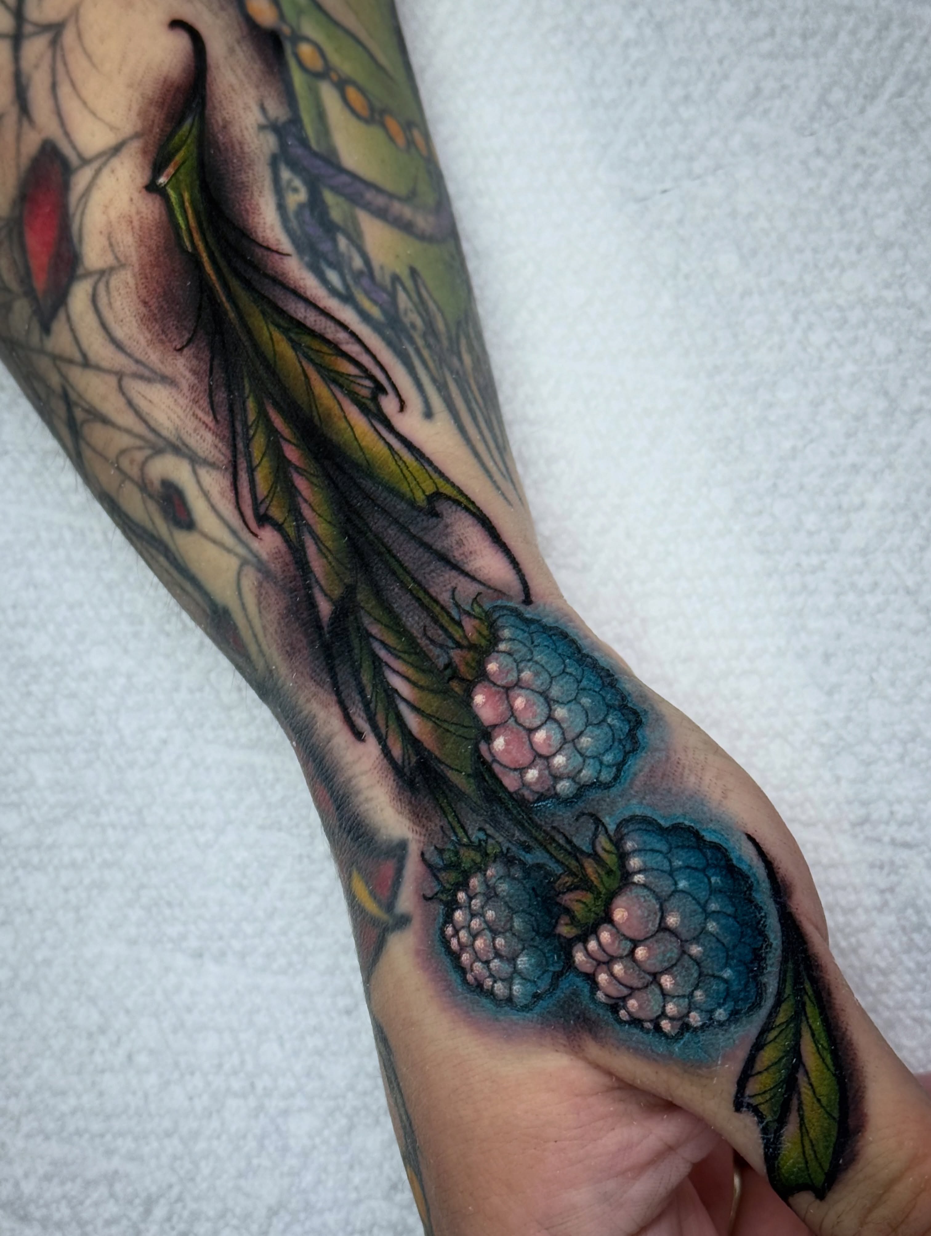 Raspberries realism tattoo on the forearm by Mitch McGarry