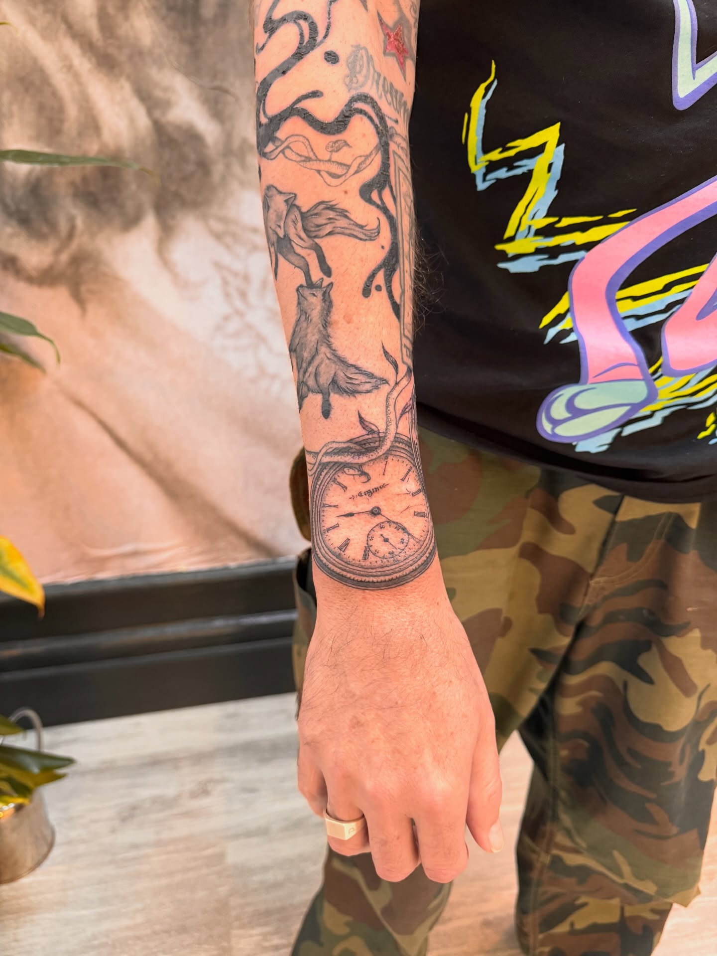 Clock and fox black and grey tattoo on the forearm by Sam Padilla