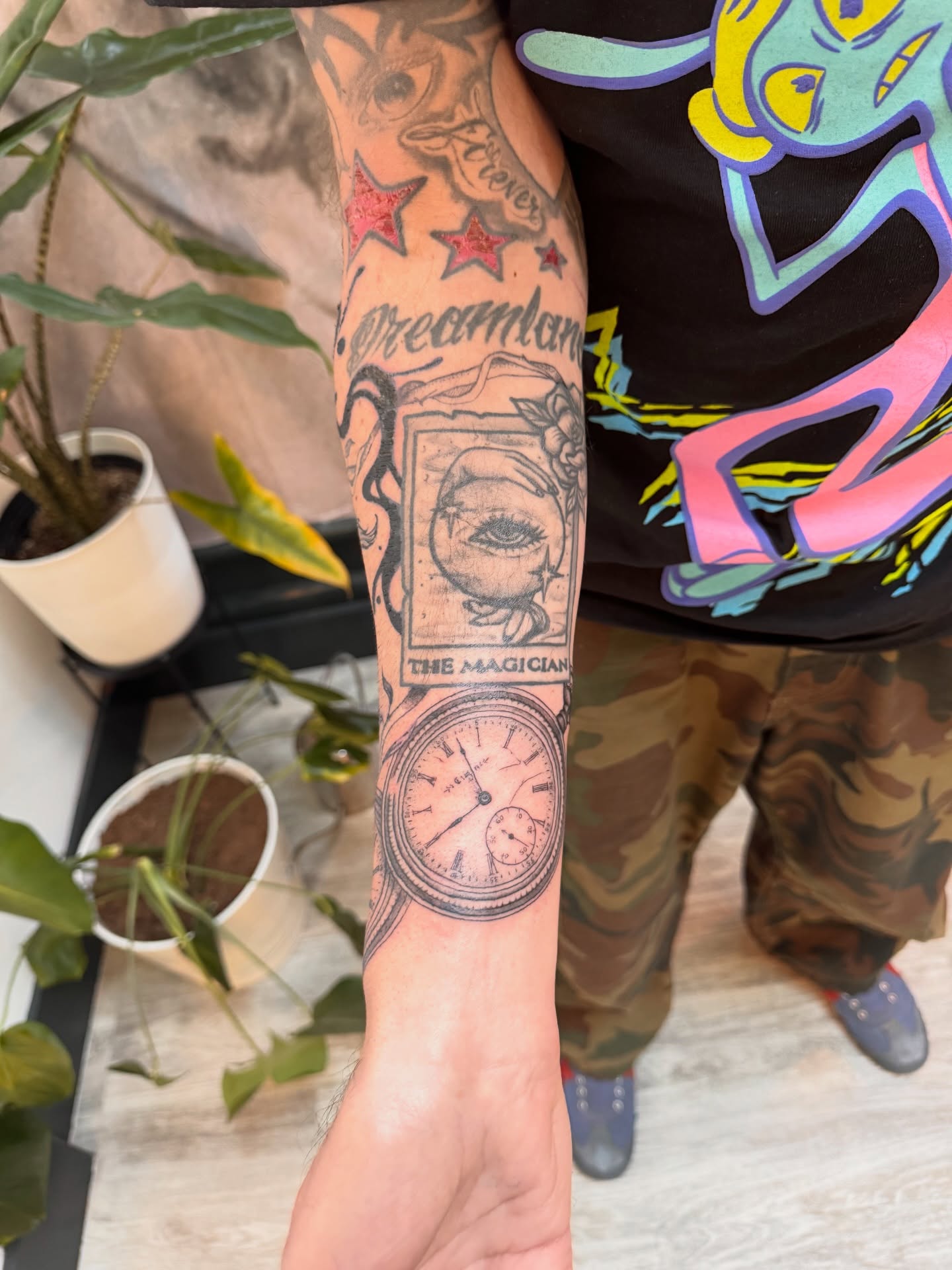 The magician realism tattoo on the forearm by Sam Padilla