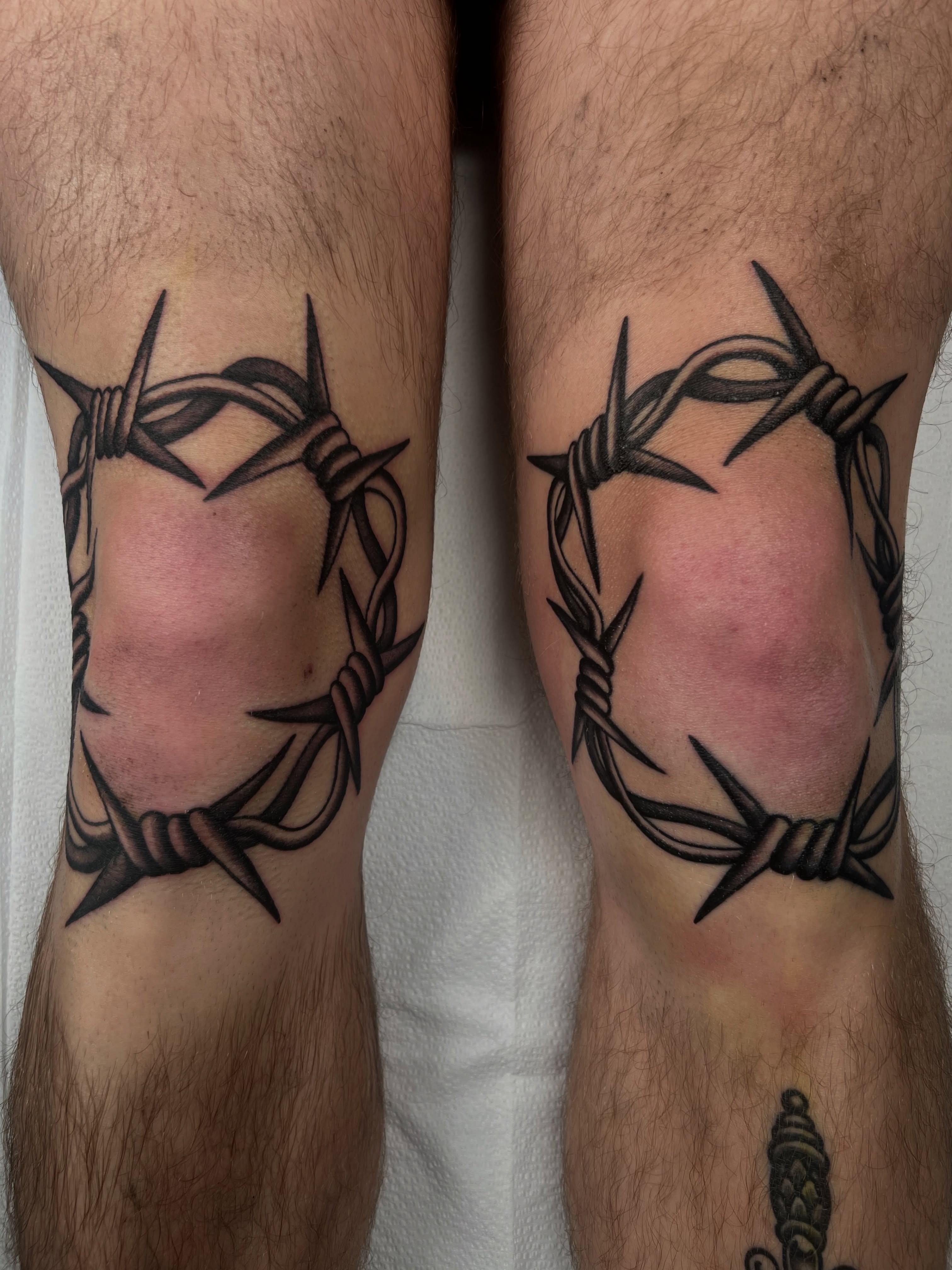 Barbed wire black and grey tattoo on the thigh by Cassidy Maples