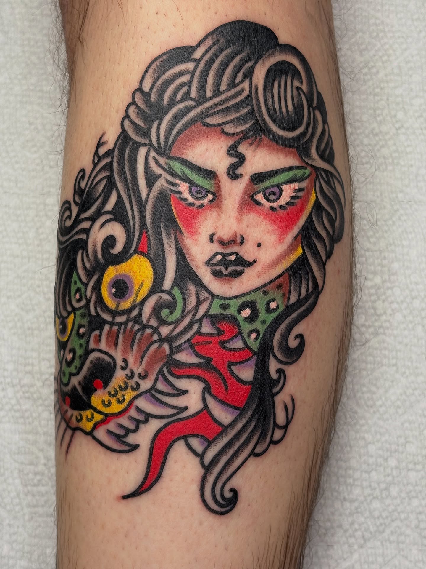 Woman with fish American traditional tattoo on the forearm by Andrew Silva