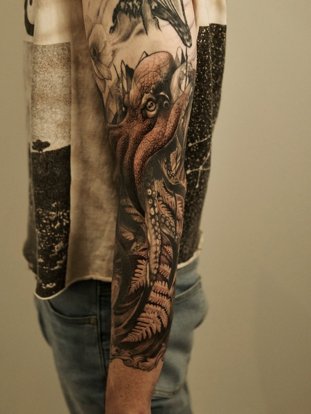 Octopus and ferns realism tattoo on the forearm by Ray Quinday