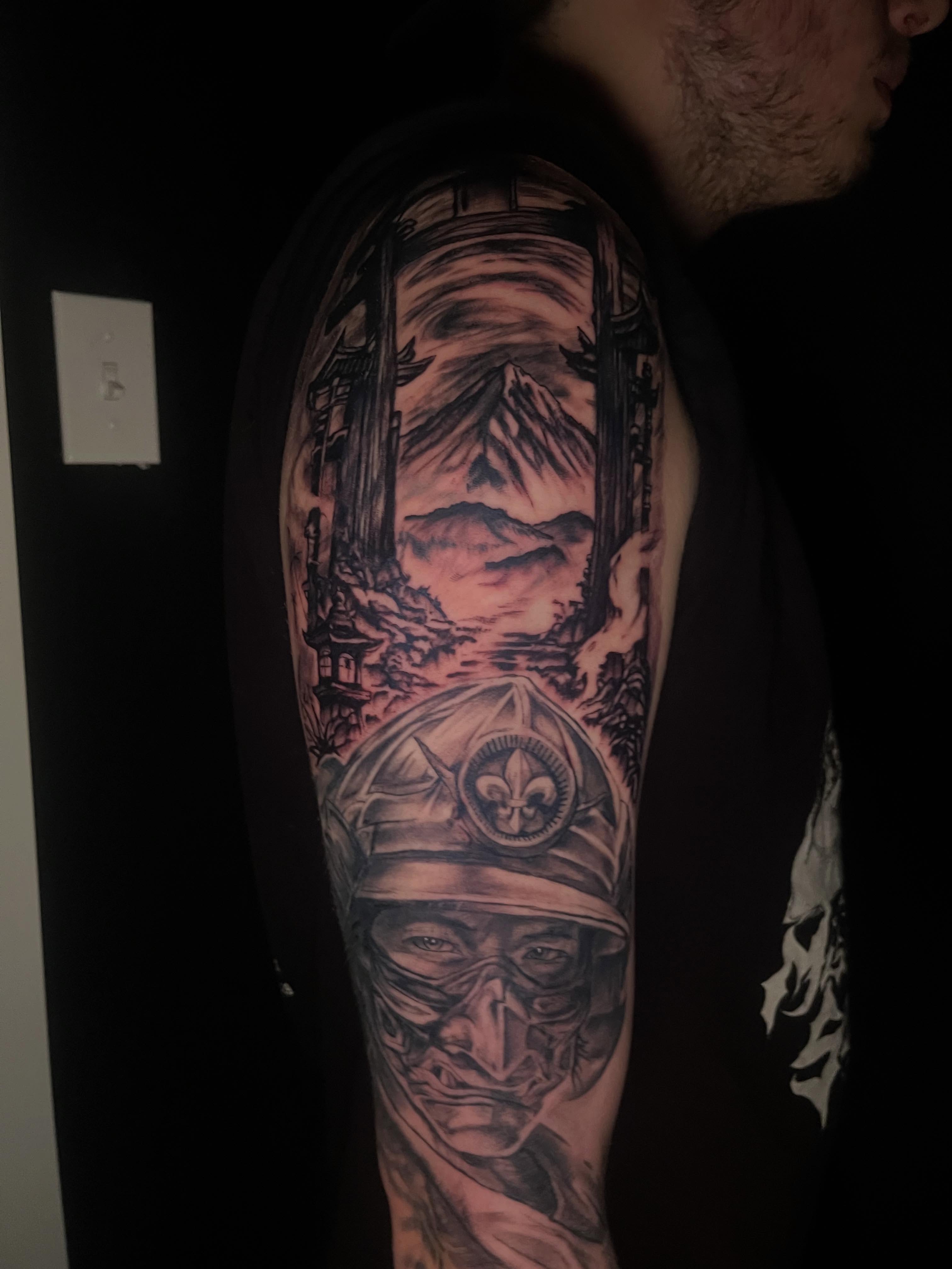 Soldier with mountain landscape realism tattoo on the forearm by Deville Pinson