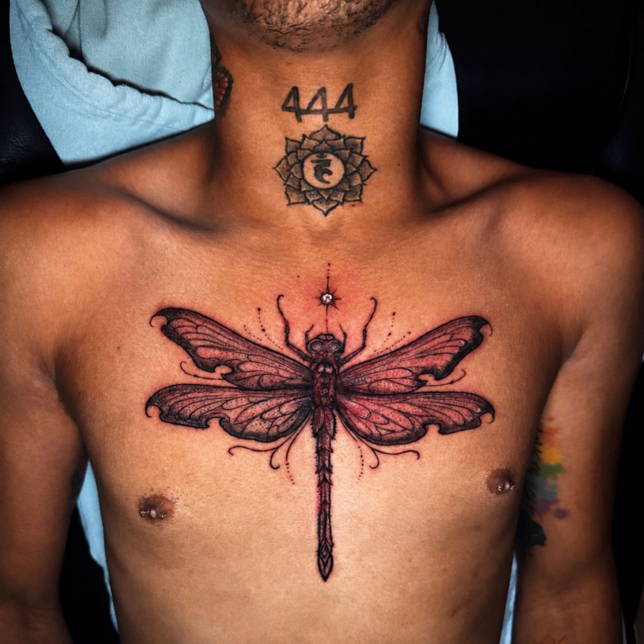 Dragonfly dotwork tattoo on the chest by Kelsoink