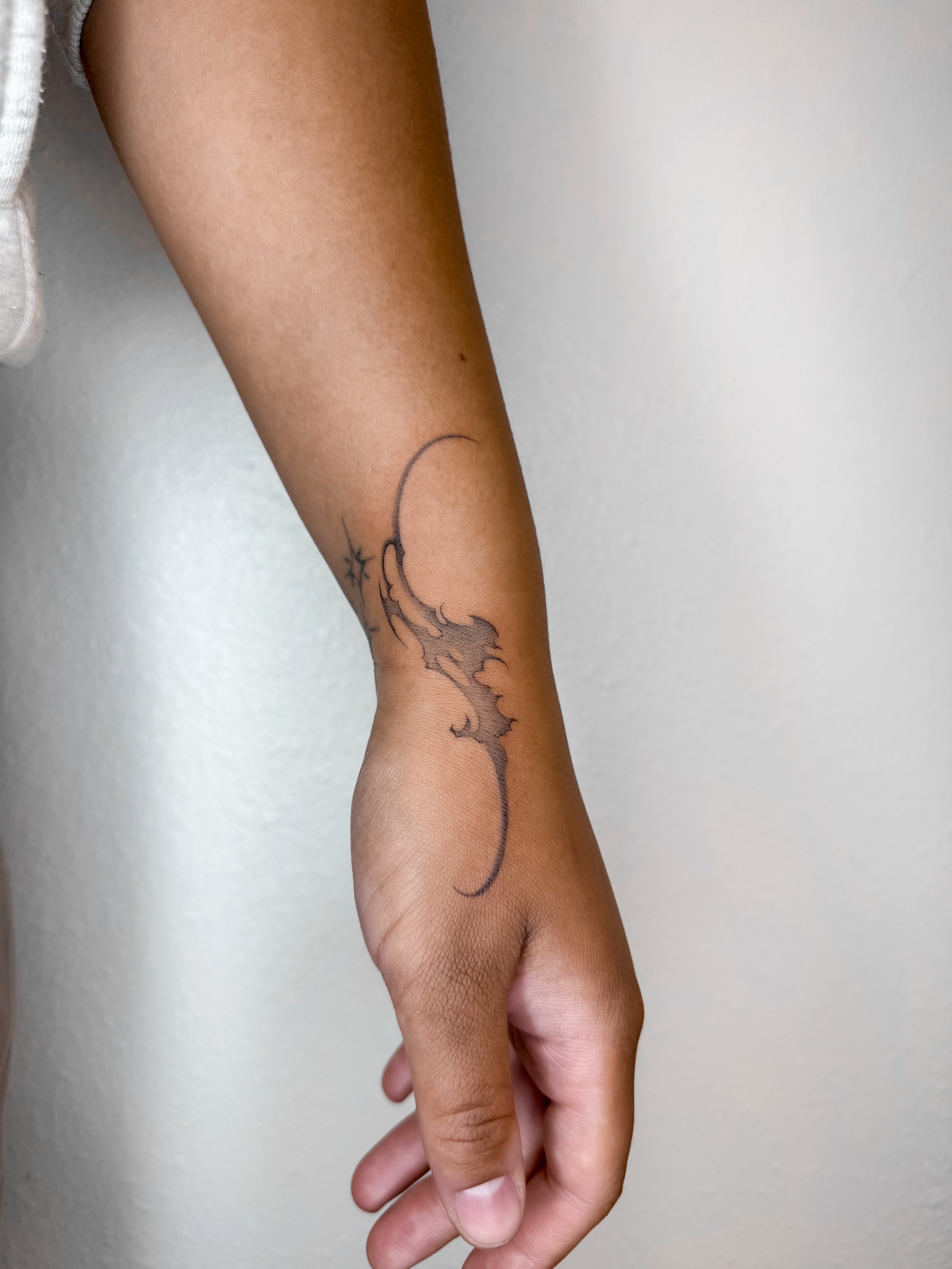 Dragon black and grey tattoo on the forearm by Rylee