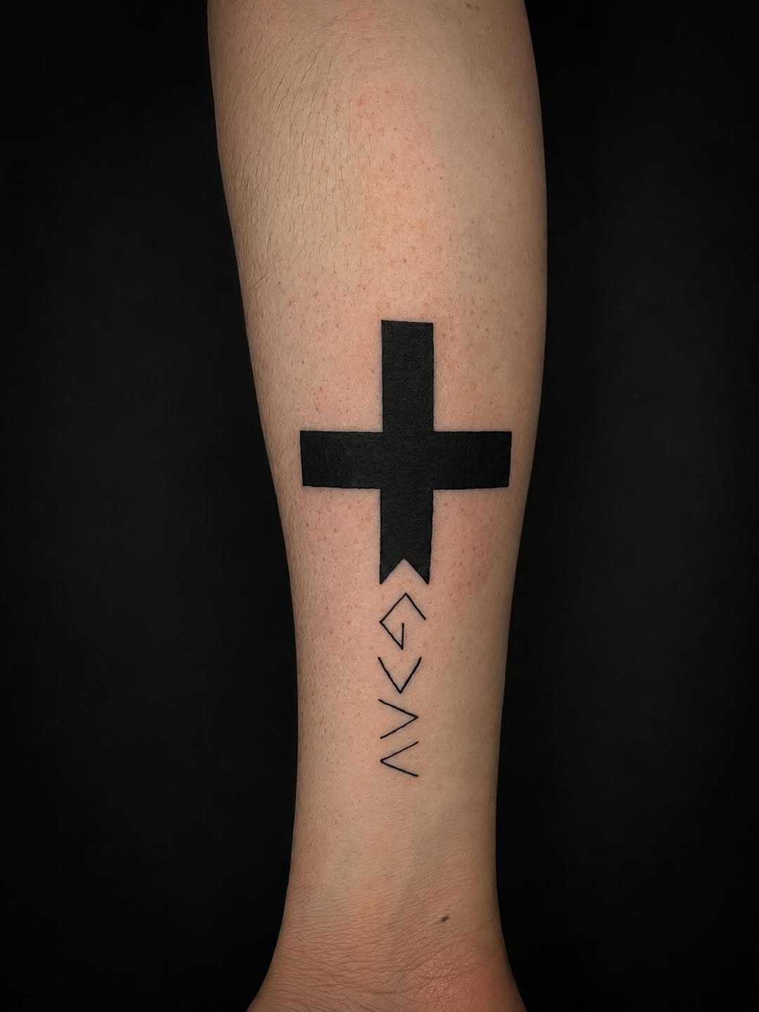 Cross and symbols tattoo on the forearm by 𝚃𝙰𝚃𝚃𝙾𝙾 𝙰𝚁𝚃𝙸𝚂𝚃, Charlotte, North Carolina