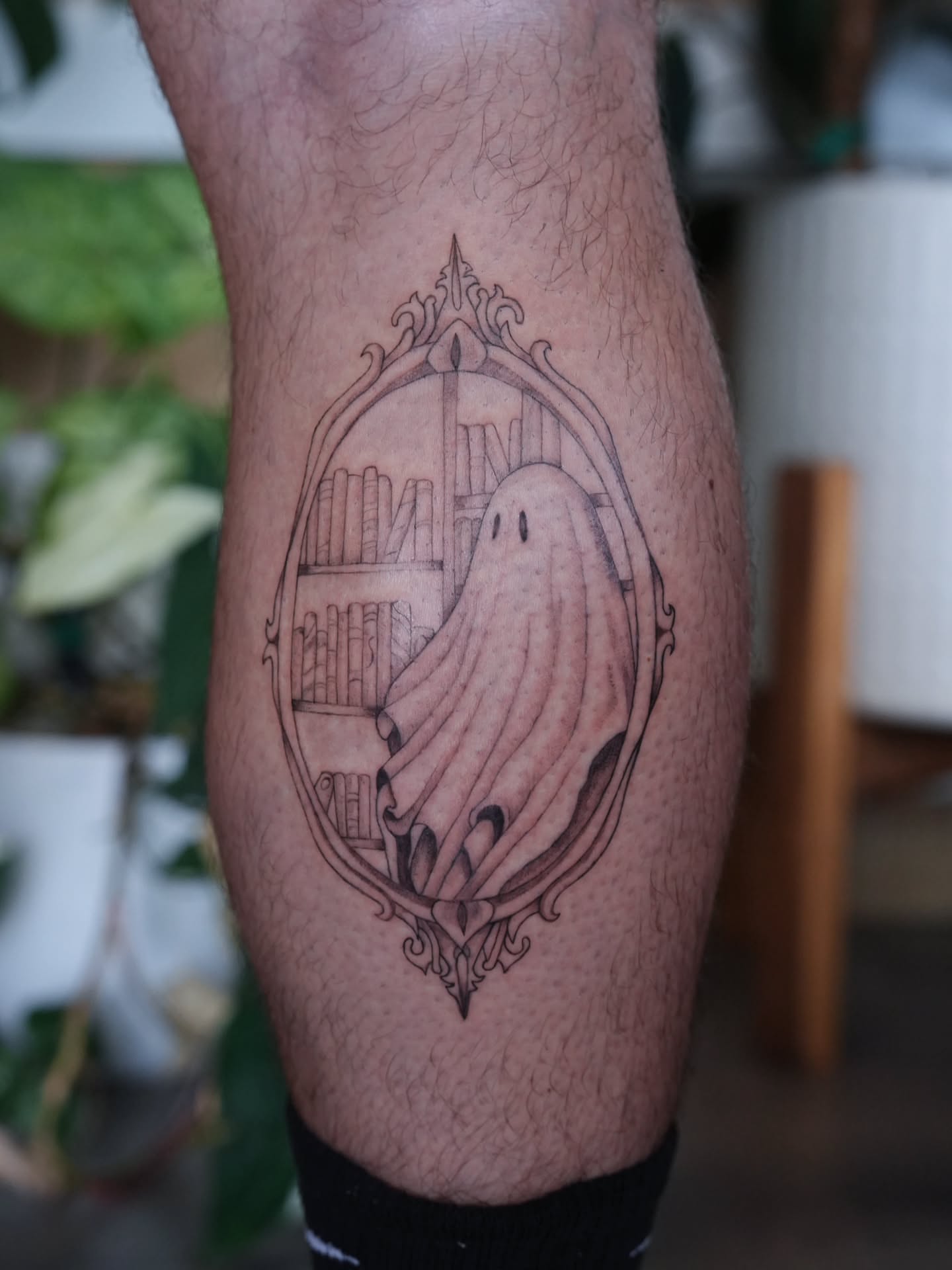Ghost and bookshelf black and grey tattoo on the forearm by Alex ▪︎ Tattoo Apprentice