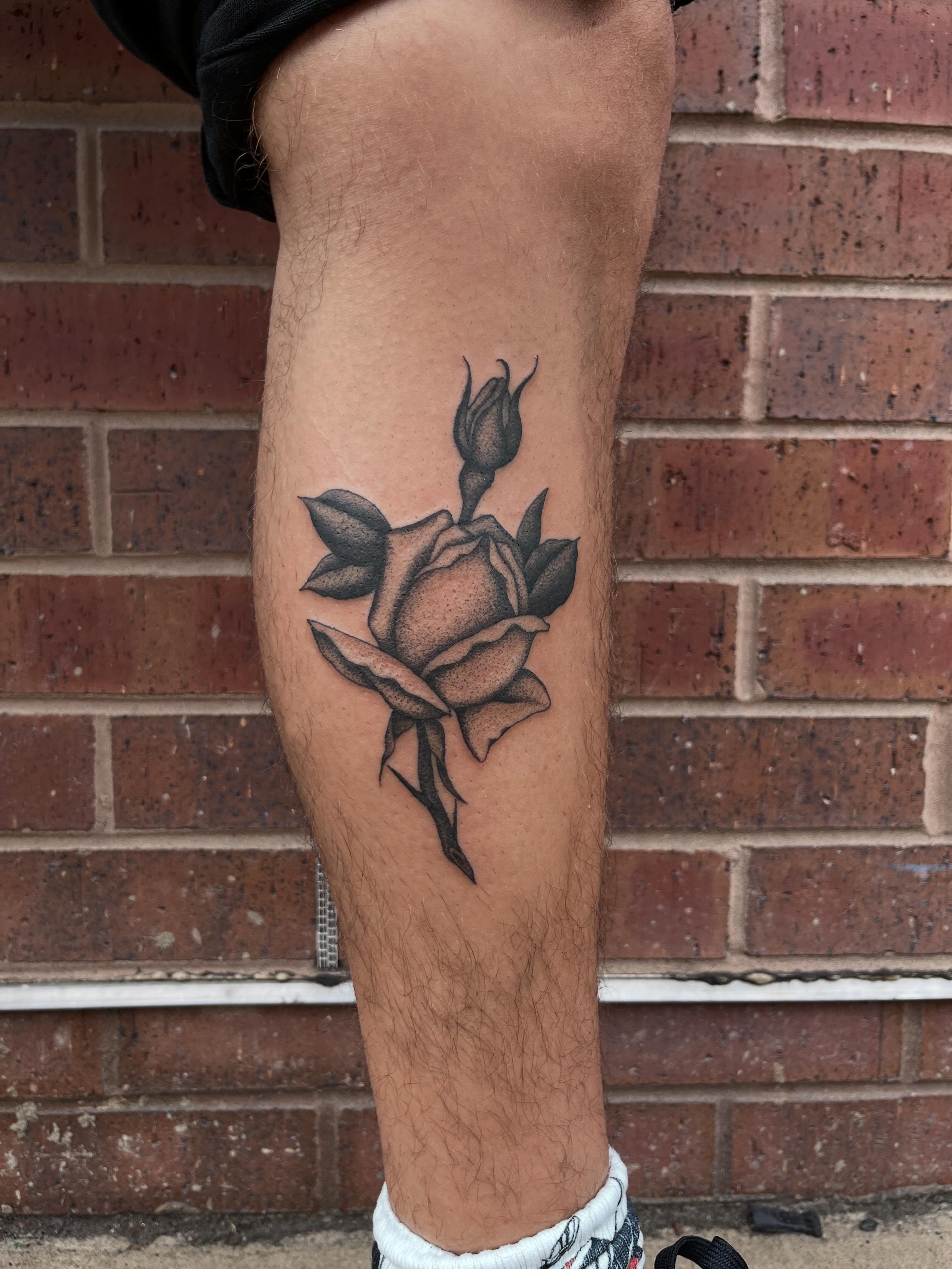 Rose black and grey tattoo on the calf by Jackson Kirchhoff