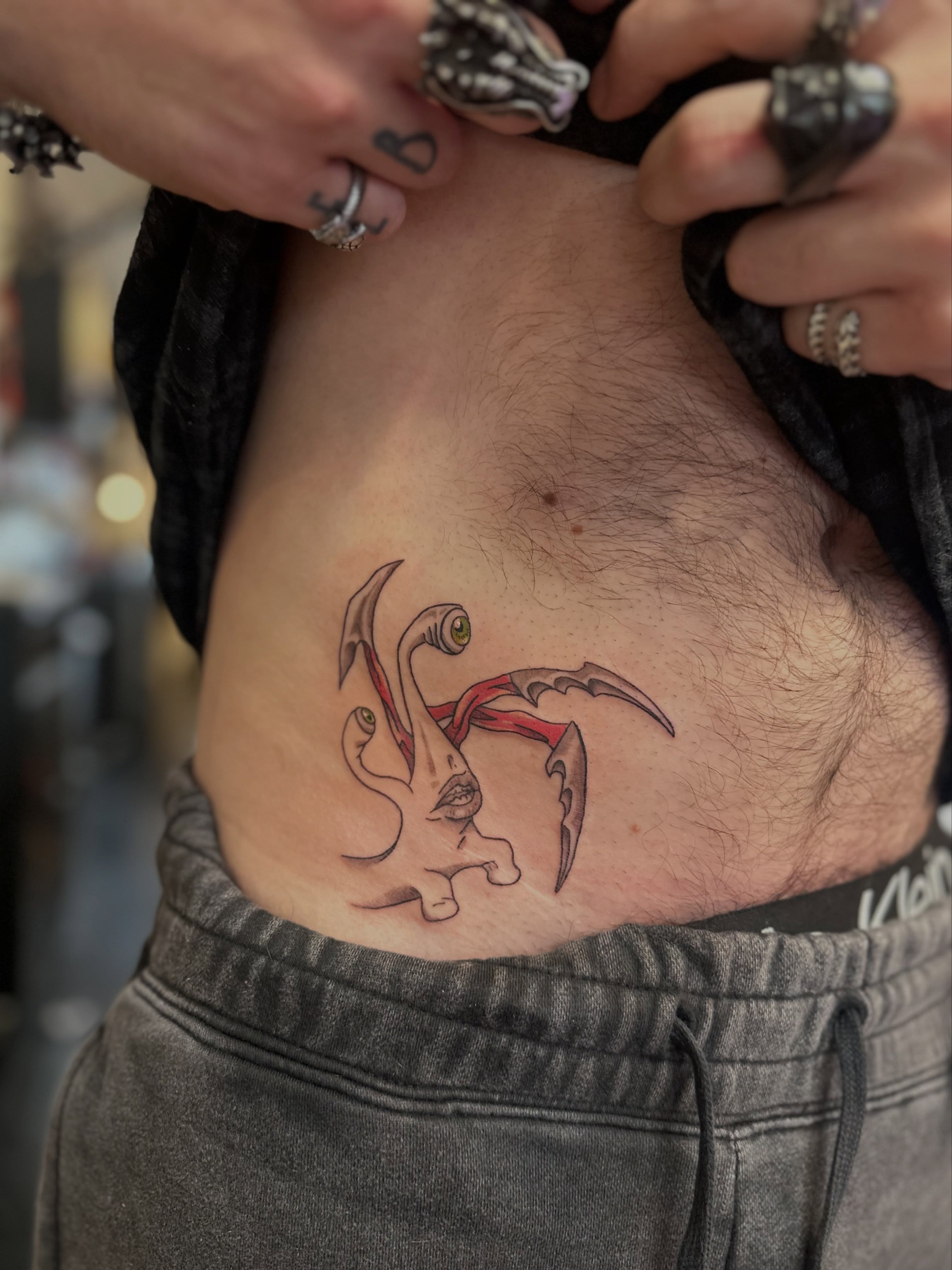 Octopus neo-traditional tattoo on the ribs by Macy Rae