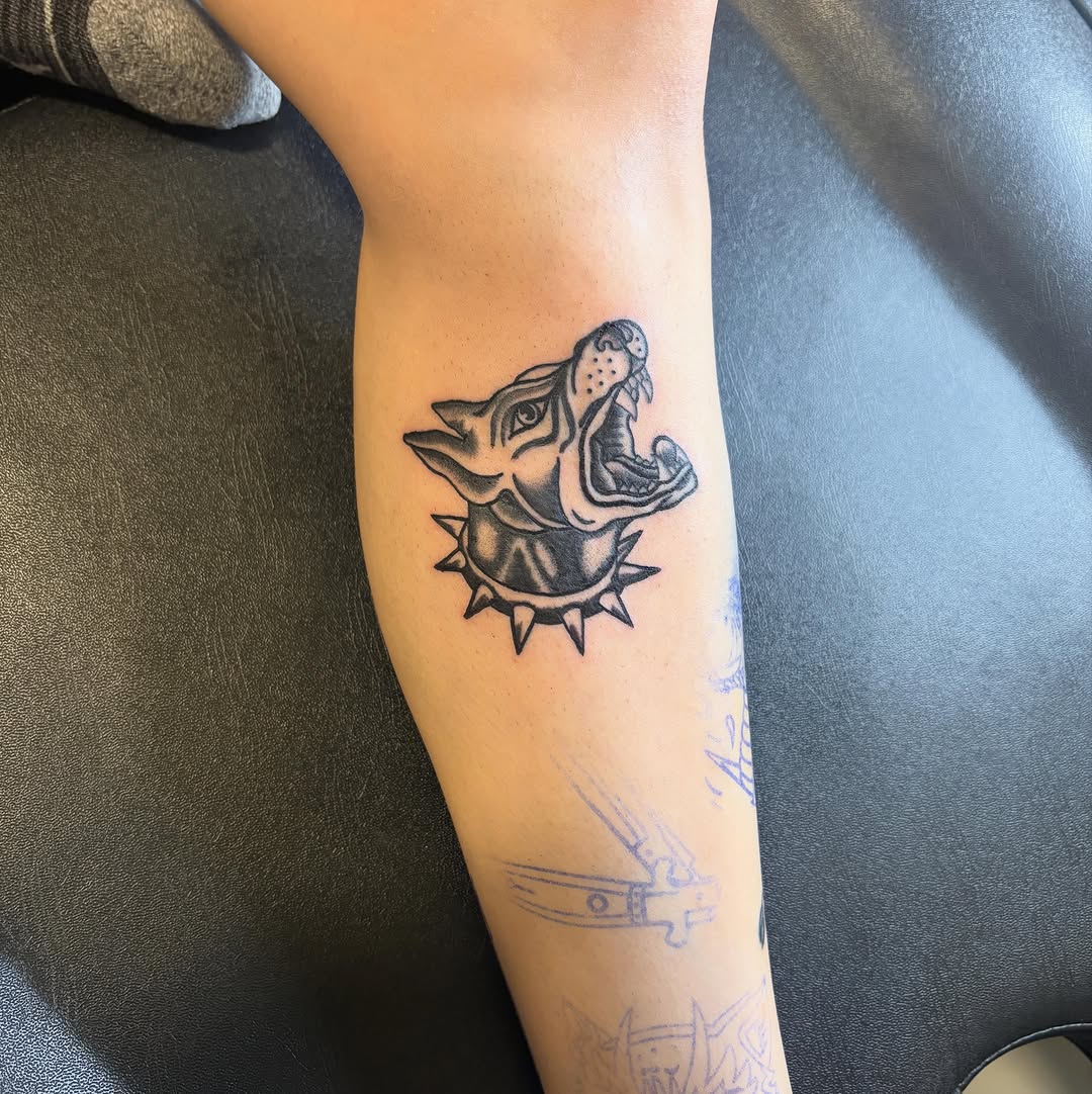 Dog head with spiked collar realism tattoo on the forearm by sams tattoos