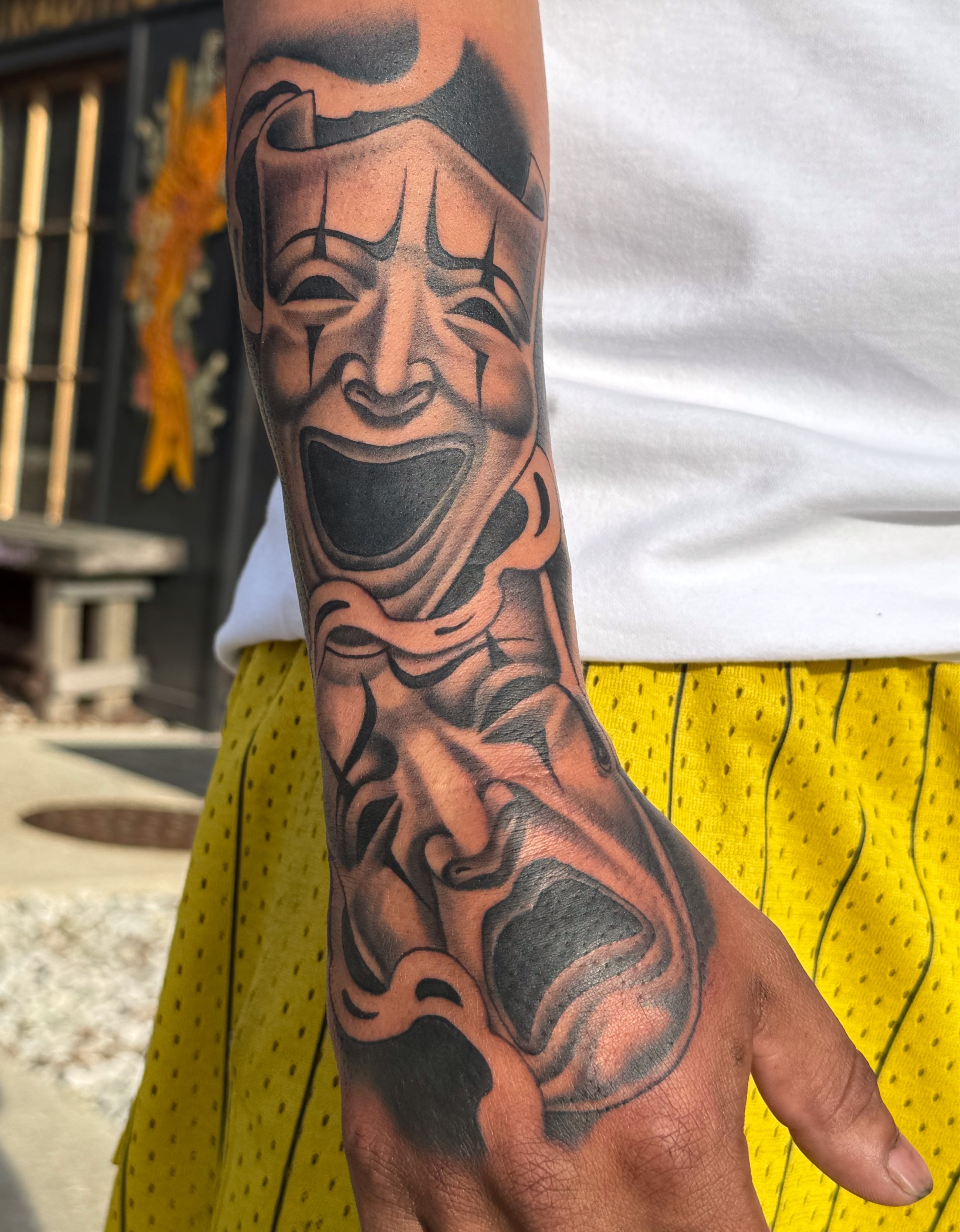 Clown mask black and grey tattoo on the forearm by Eli