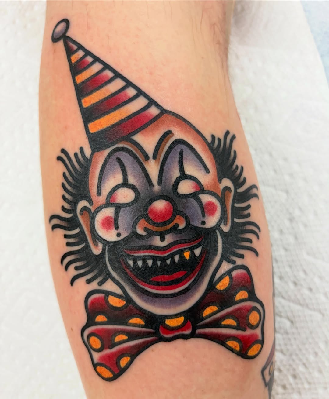 Clown American traditional tattoo on the forearm by Adrian Godoy