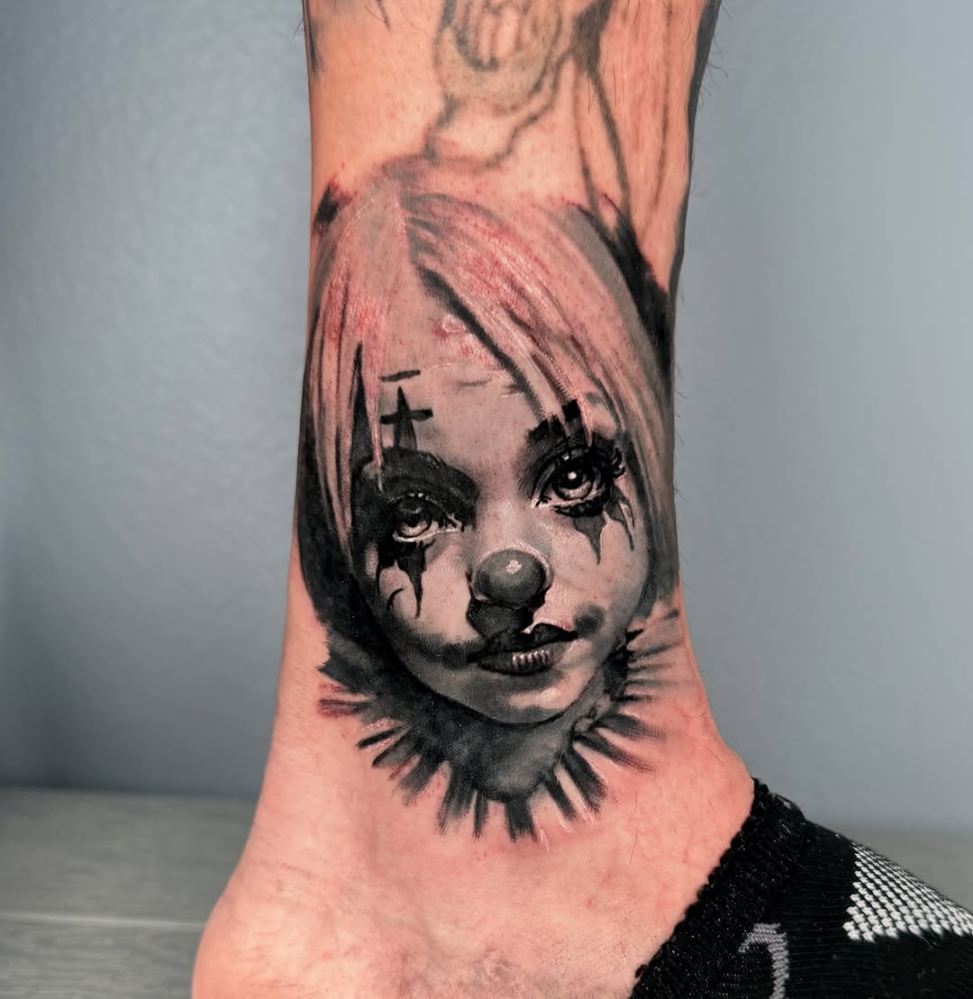 Clown face dark realism tattoo on the foot by Jose Carlos