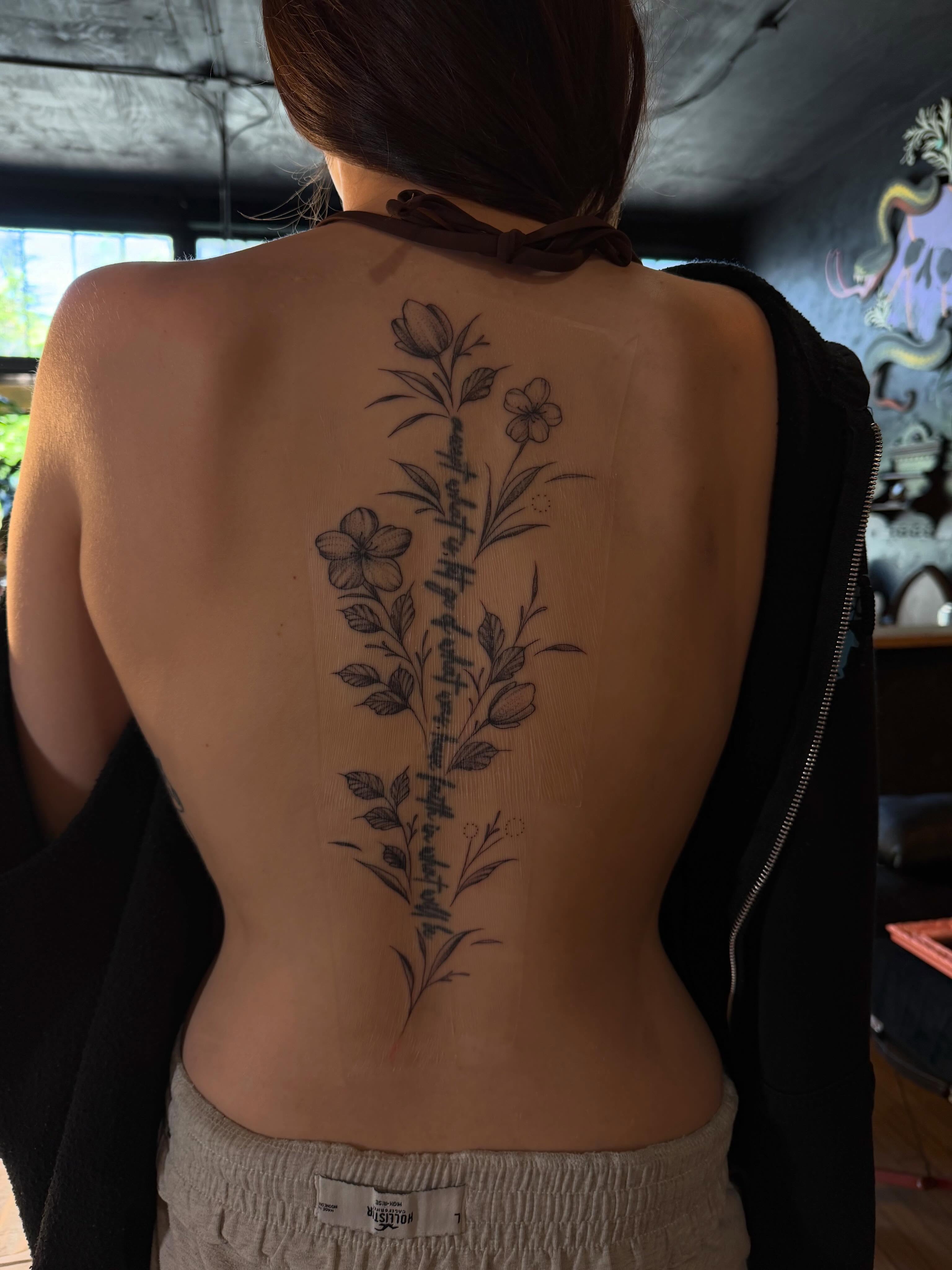 Floral arrangement black and grey tattoo on the back by Allison