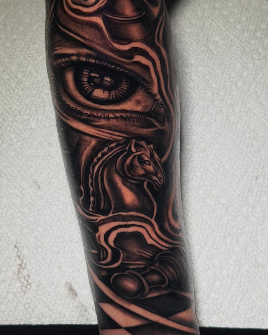 Eye, horse, chess pieces realism tattoo on the forearm by Nj Tattoo Artist Inkdyou, Bloomfield, New Jersey