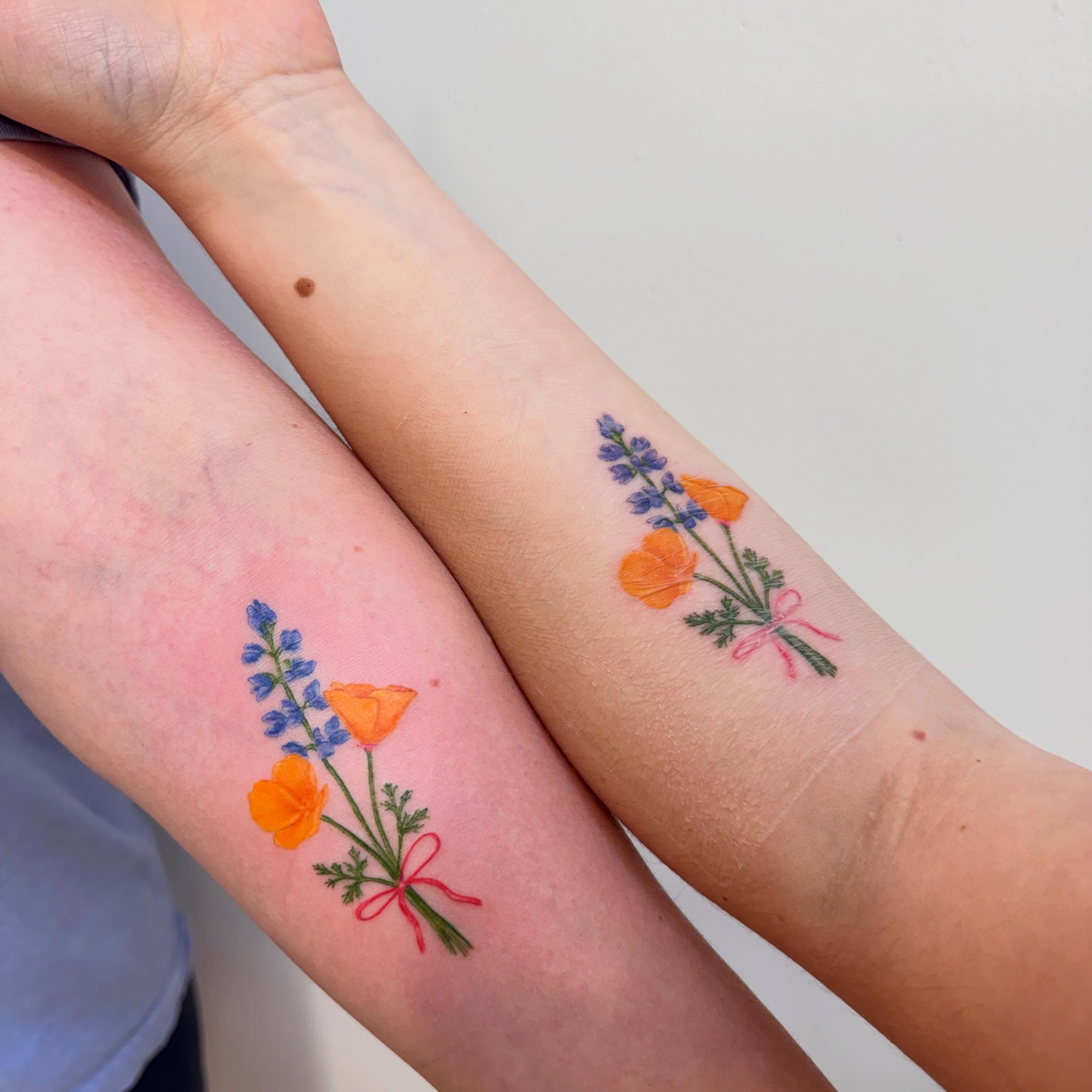 Flower bouquet watercolor tattoo on the forearm by Enda 🧚🏻‍♀️
