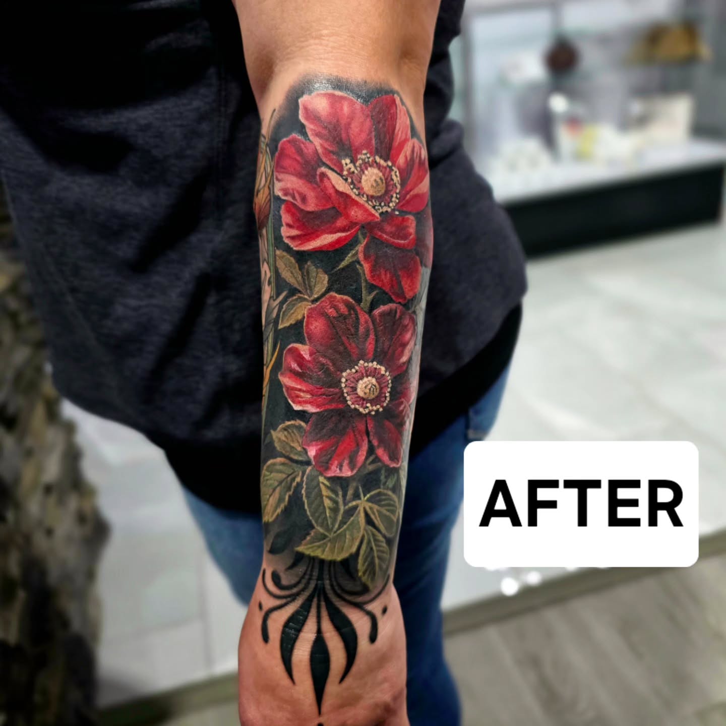 Red roses realism tattoo on the forearm by Julia Oravets