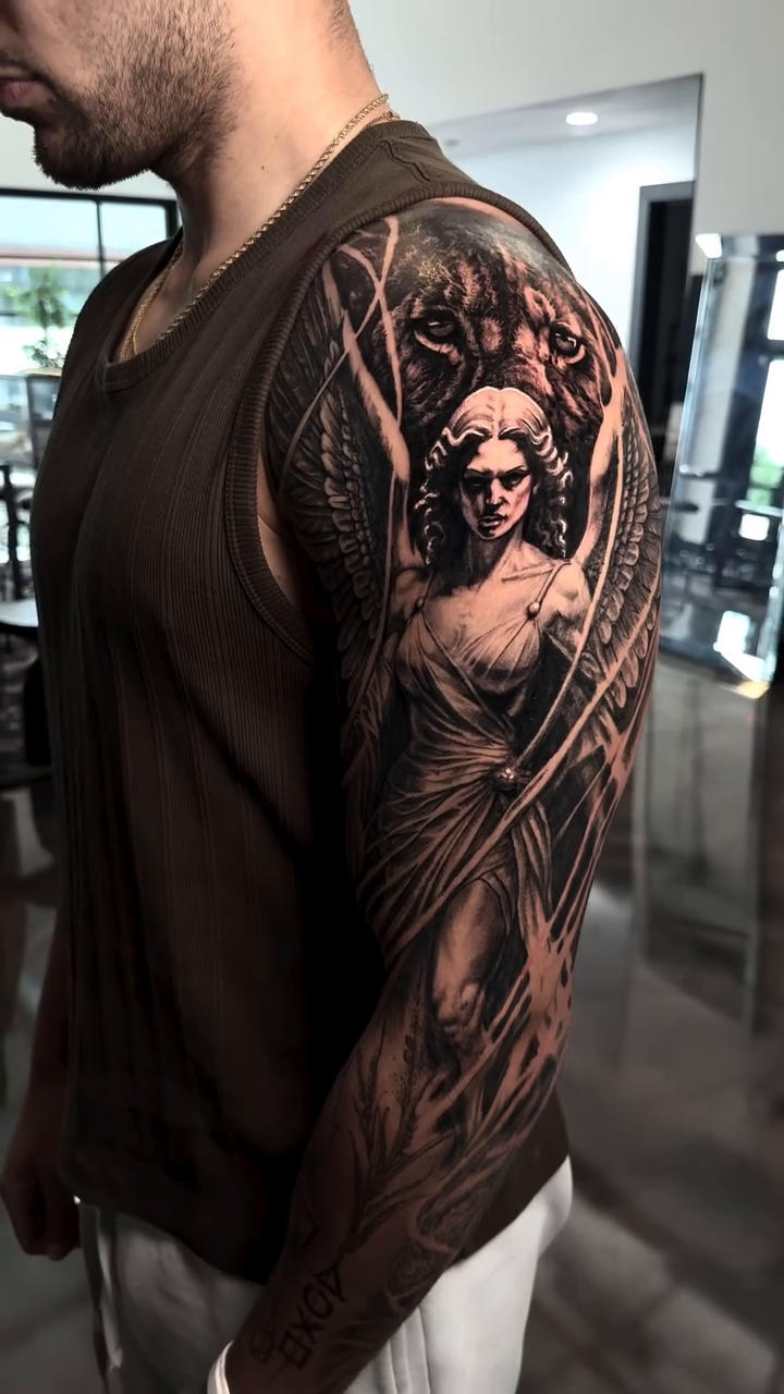 Angel and lion head realism tattoo by Cory James