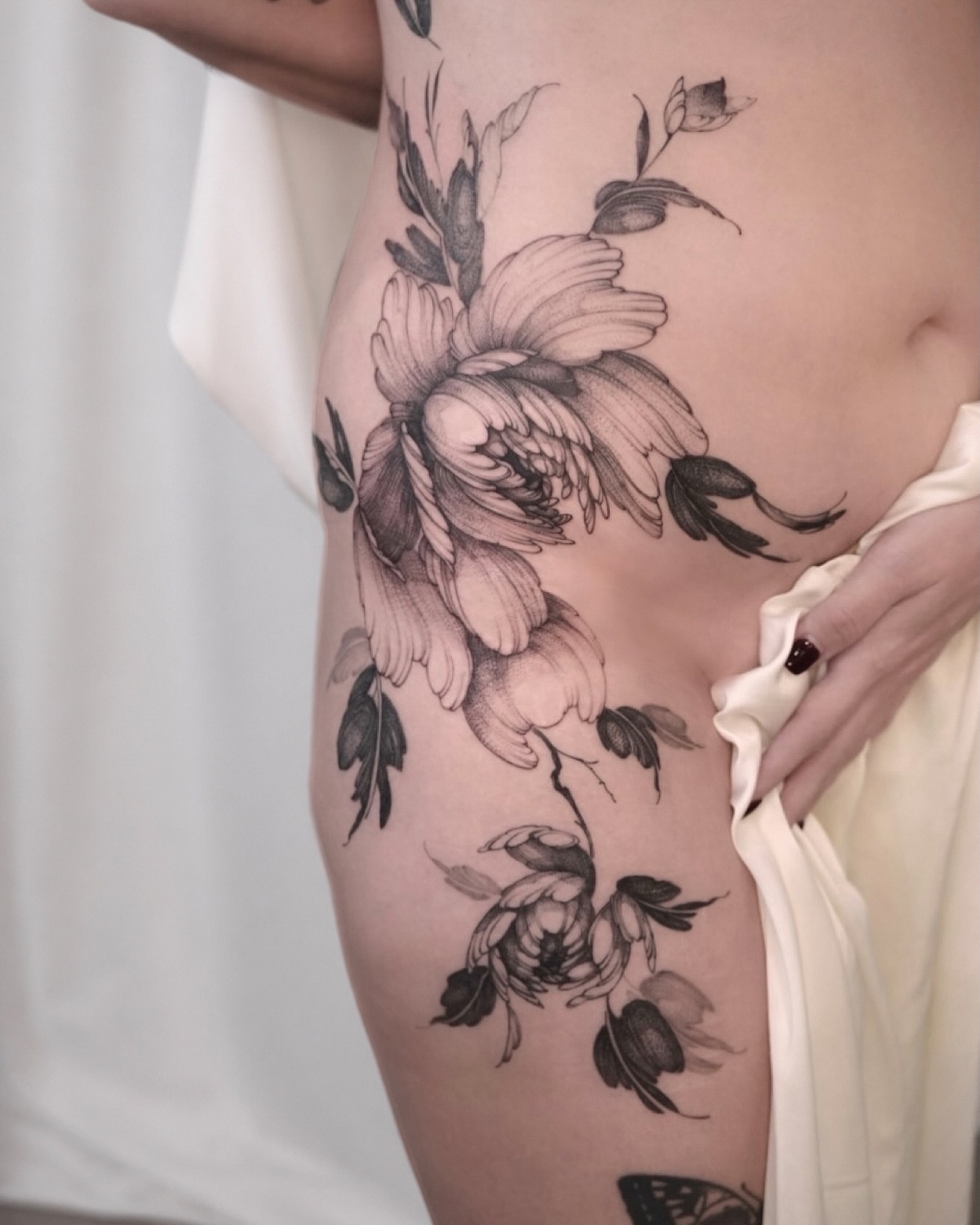 Floral arrangement black and grey tattoo on the thigh by Joy, Gold Coast, Queensland