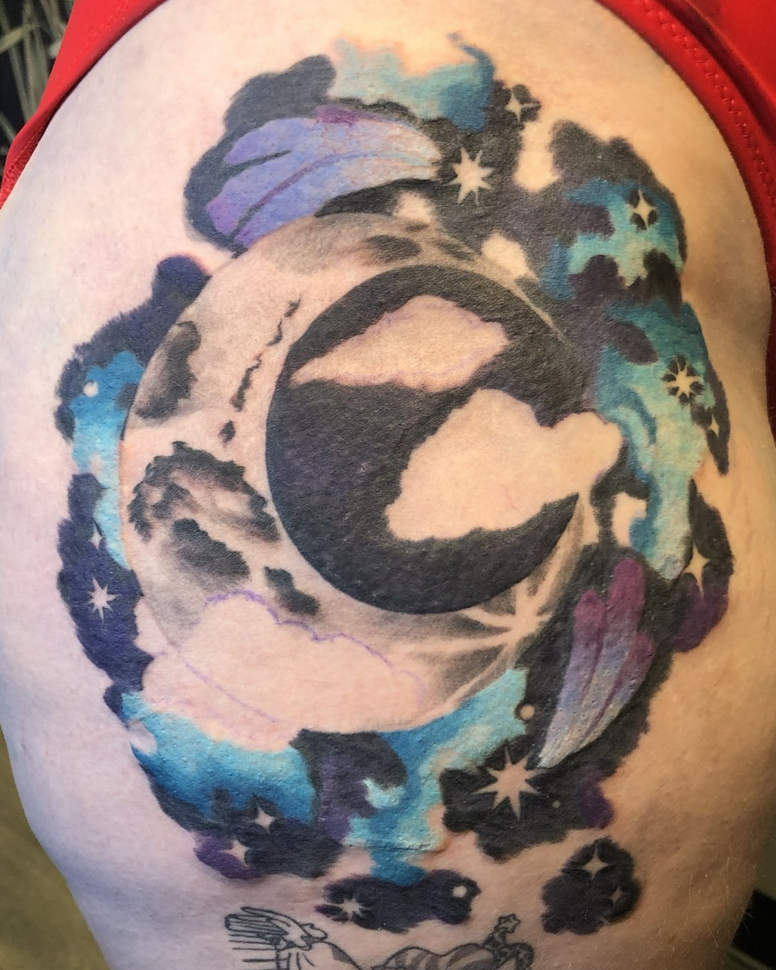 Moon and clouds watercolor tattoo on the shoulder by Rowan Lee
