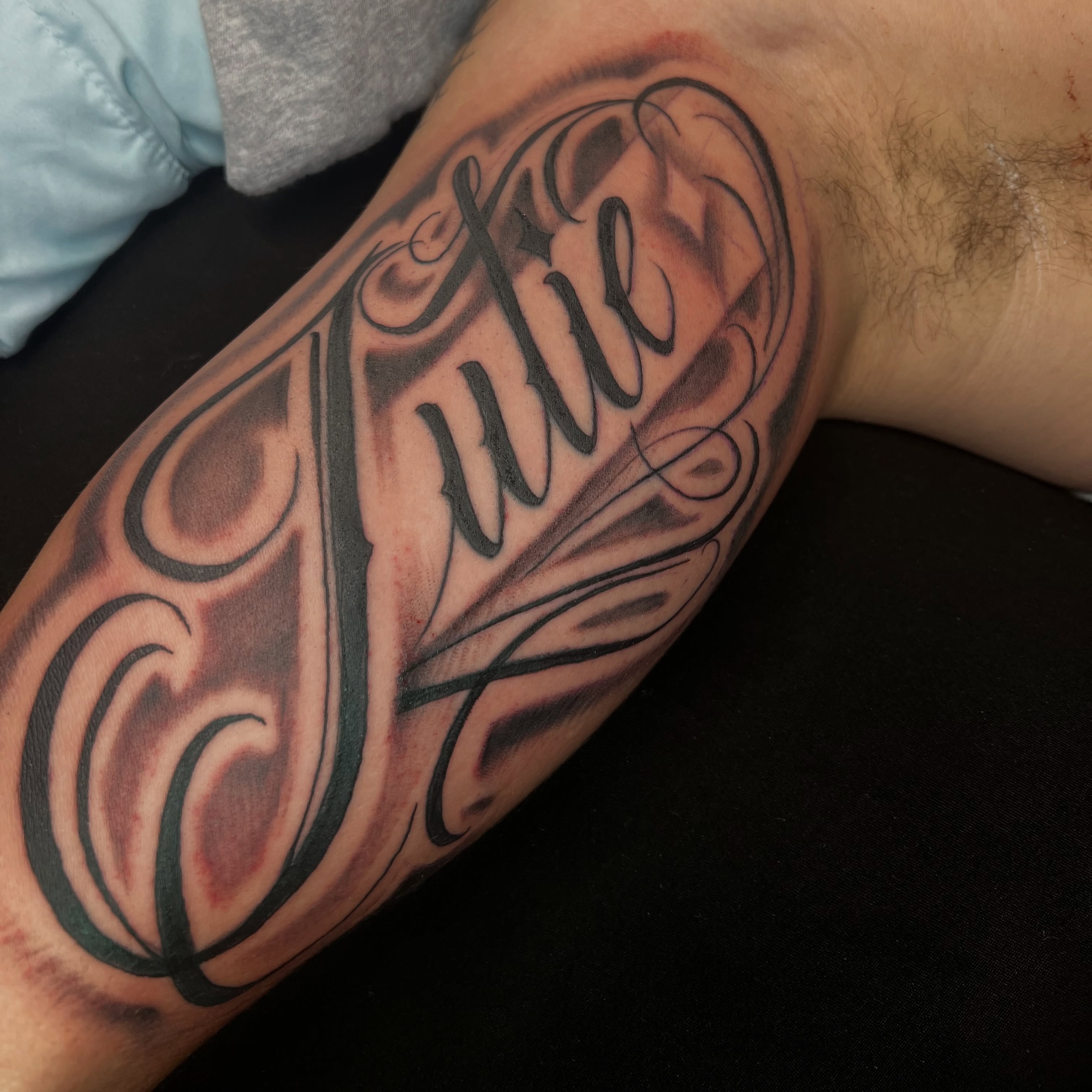 Julie lettering script tattoo on the forearm by Monstro Ink Arts Tattoos, Bakersfield, California