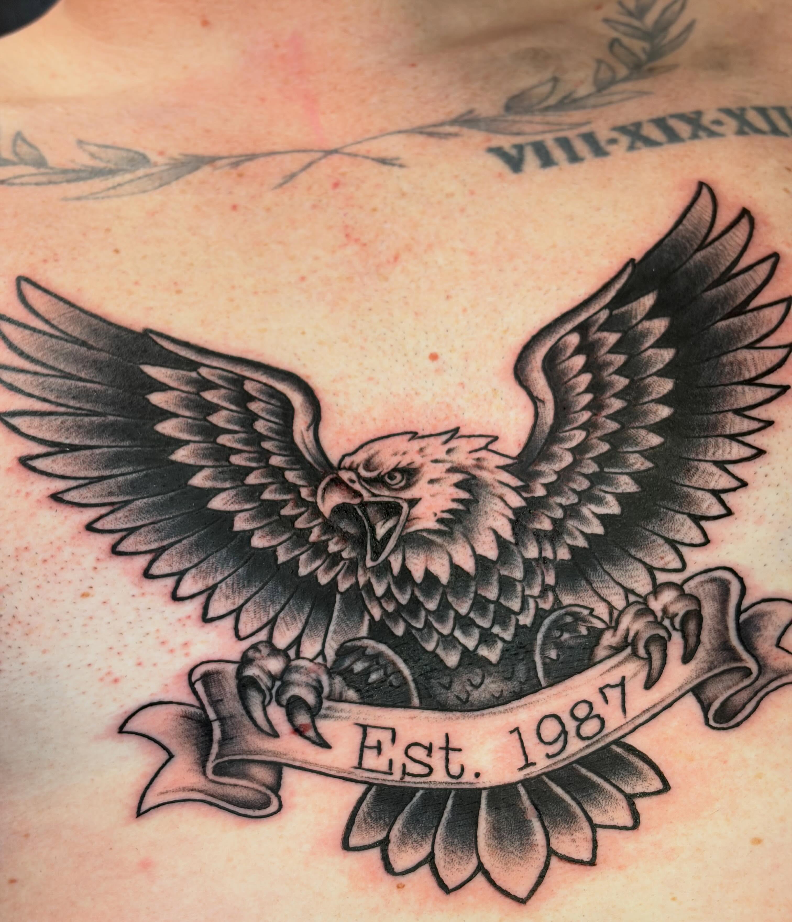 Eagle American traditional tattoo on the chest by Rachel Sellers