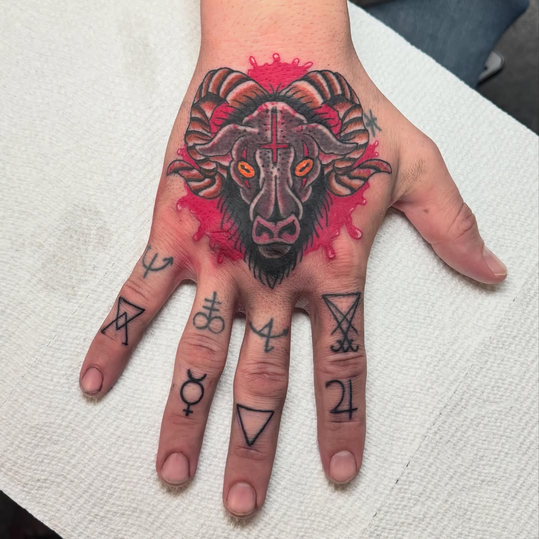 Baphomet head with occult symbols dark art tattoo on the hand by Bre