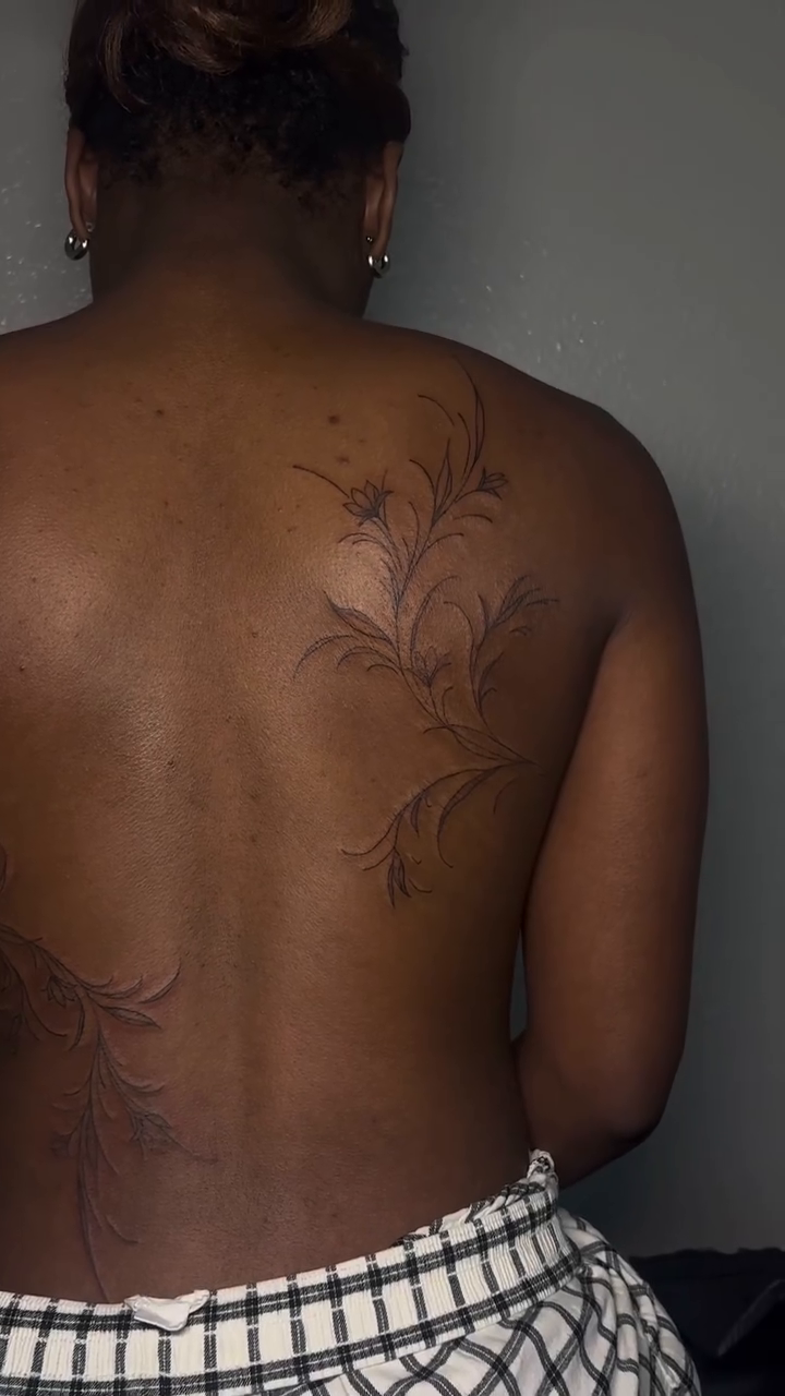 Floral vine tattoo on back blackwork tattoo on the back by Valentina