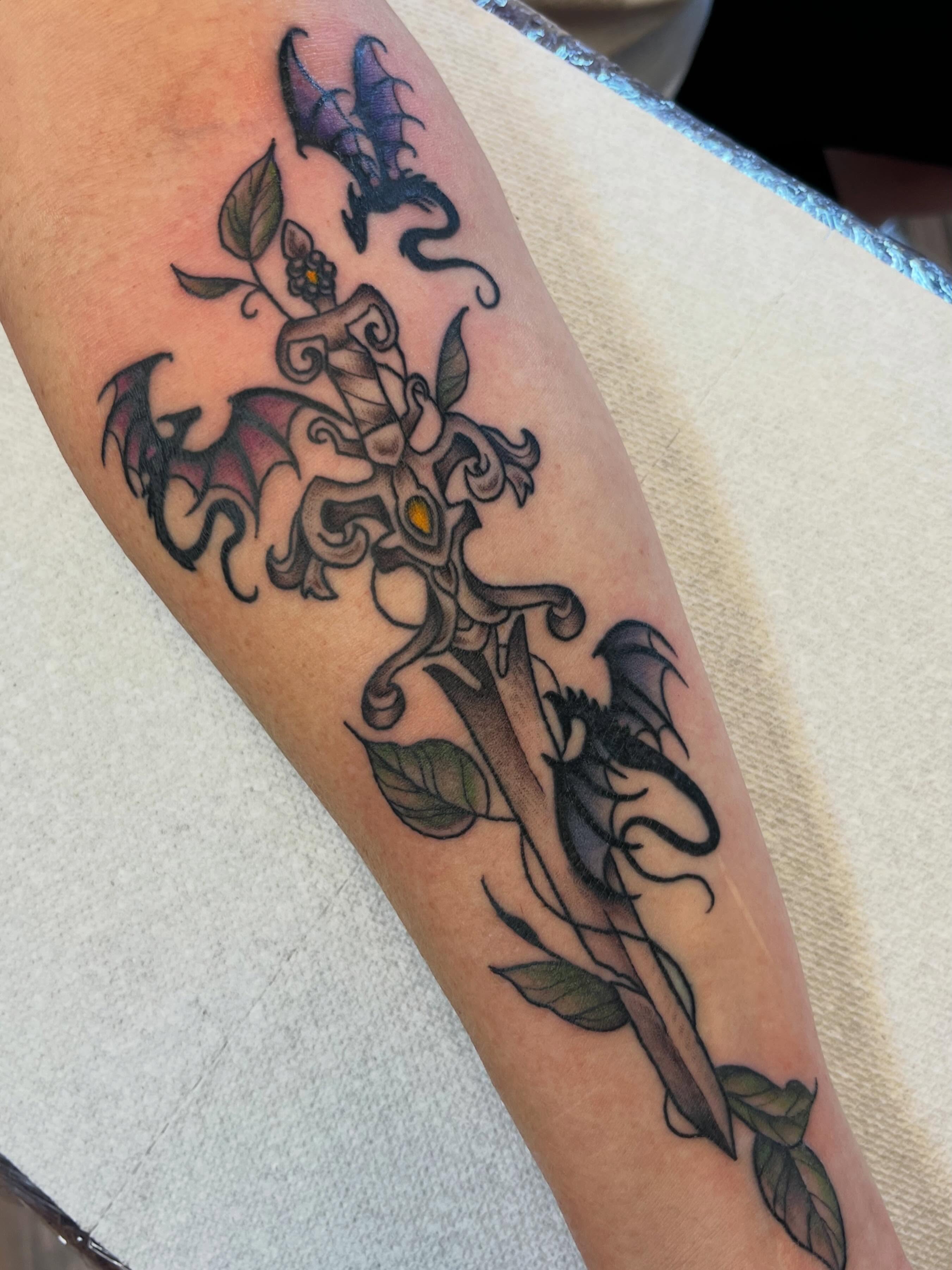 Winged creature with floral elements neo-traditional tattoo on the forearm by Danielle Lorandeau