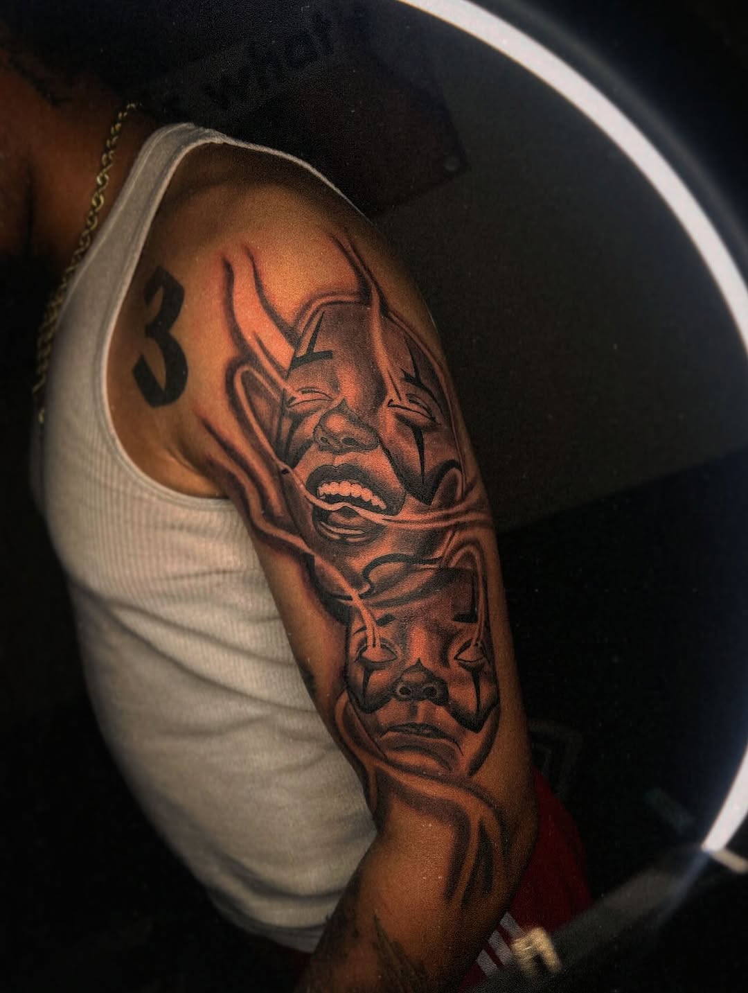 Two clown masks realism tattoo on the forearm by @tattsbyleek