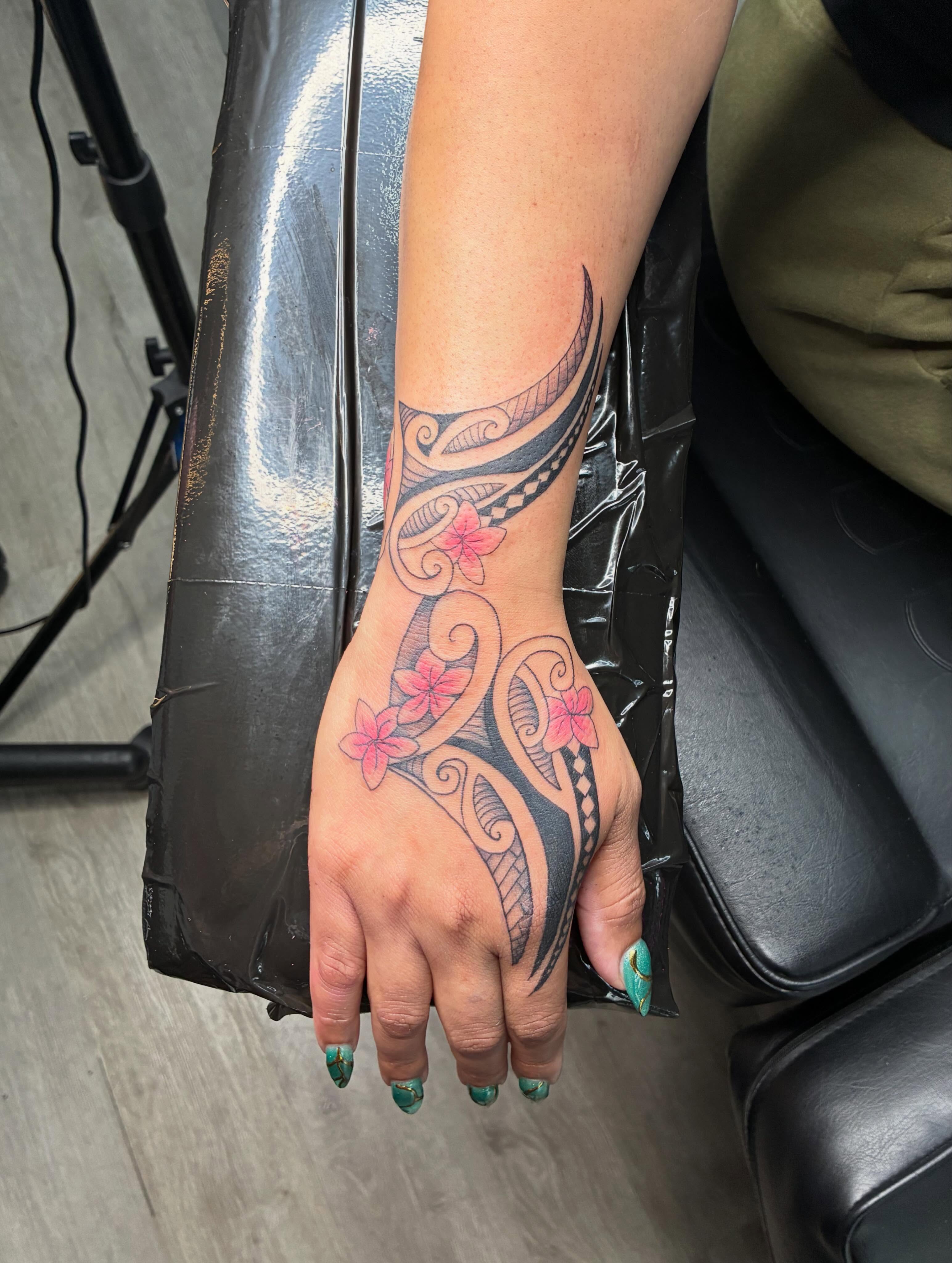 Floral pattern tribal tattoo on the hand by Tattoos by Hailey