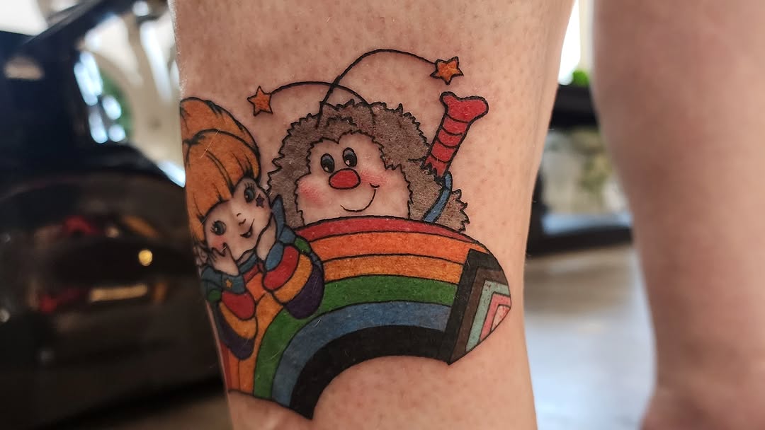Rainbow and clown new school tattoo on the forearm by mikayla