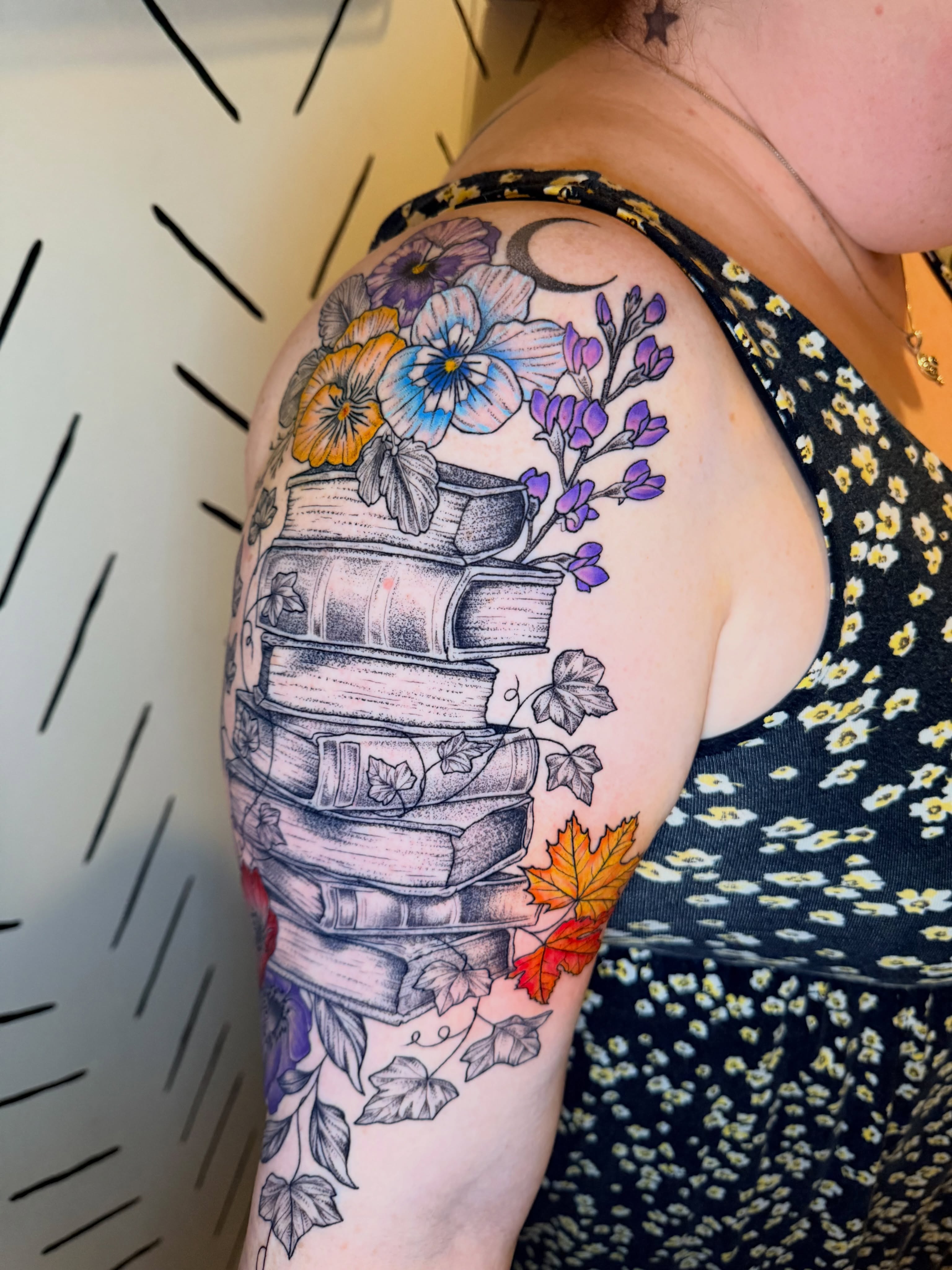 Stack of books with flowers dotwork tattoo on the shoulder by ππ£ππ€π₯π ππ¦ππ‘π, Lakewood, Colorado