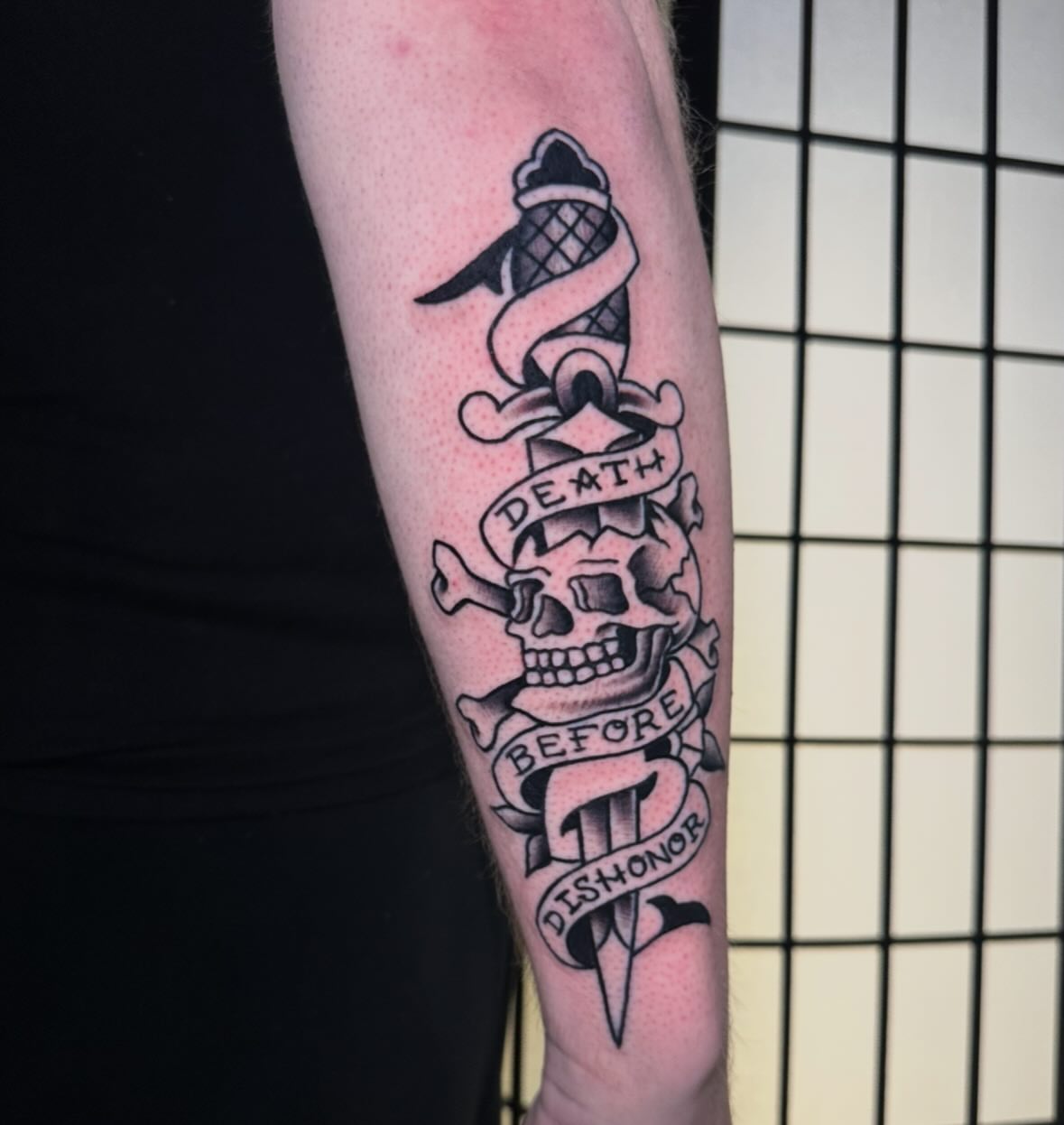 Skull and dagger American traditional tattoo on the forearm by Chi, Charlotte, North Carolina