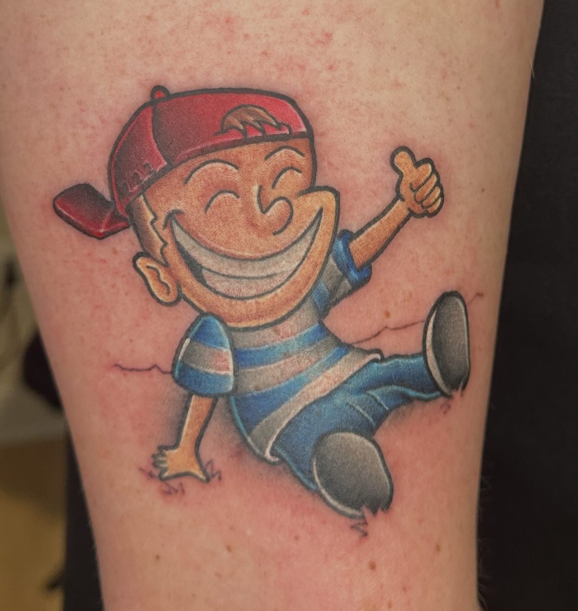 Happy cartoon boy American traditional tattoo on the forearm by Chi, Charlotte, North Carolina