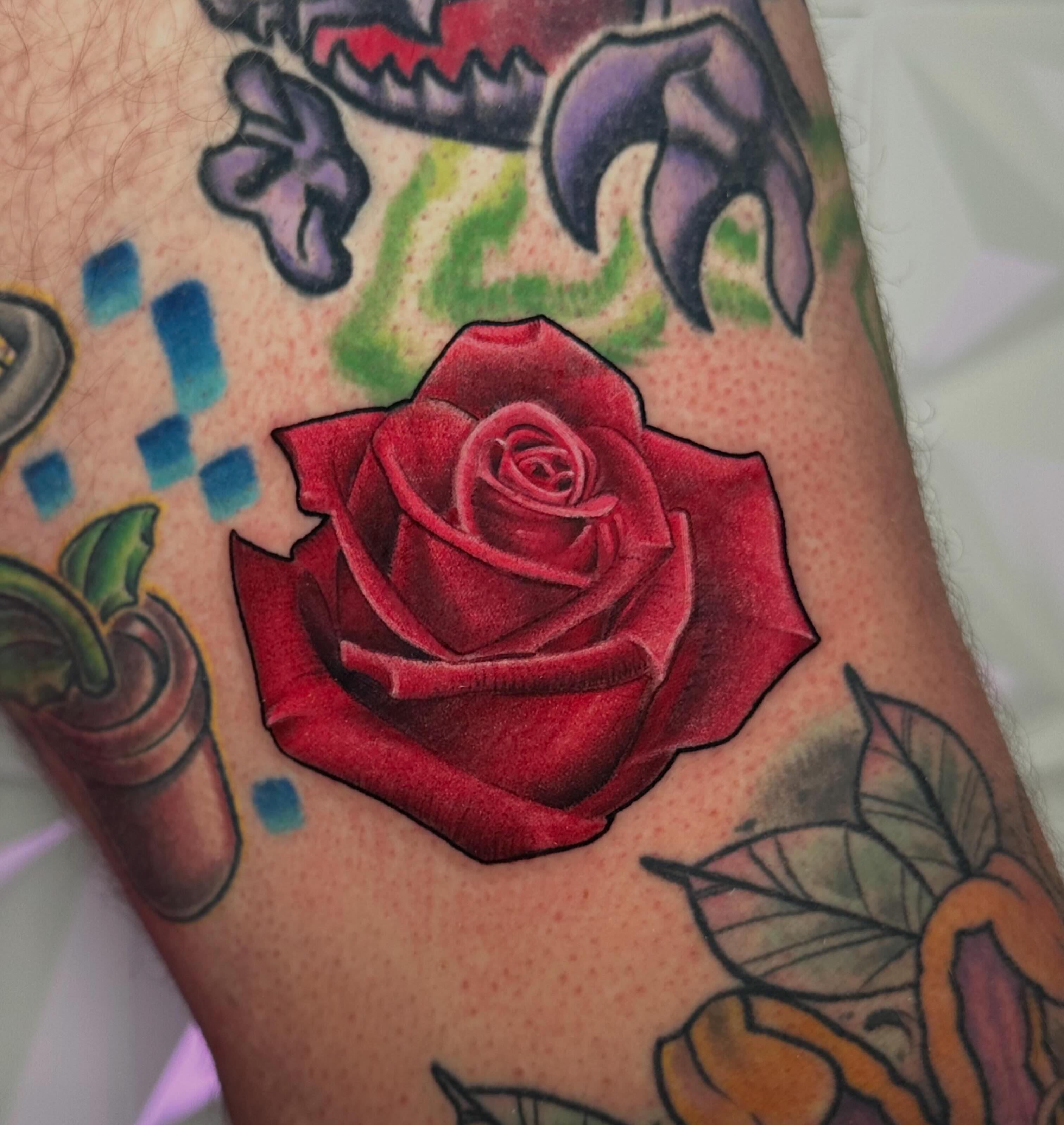 Red rose American traditional tattoo on the forearm by Chi, Charlotte, North Carolina