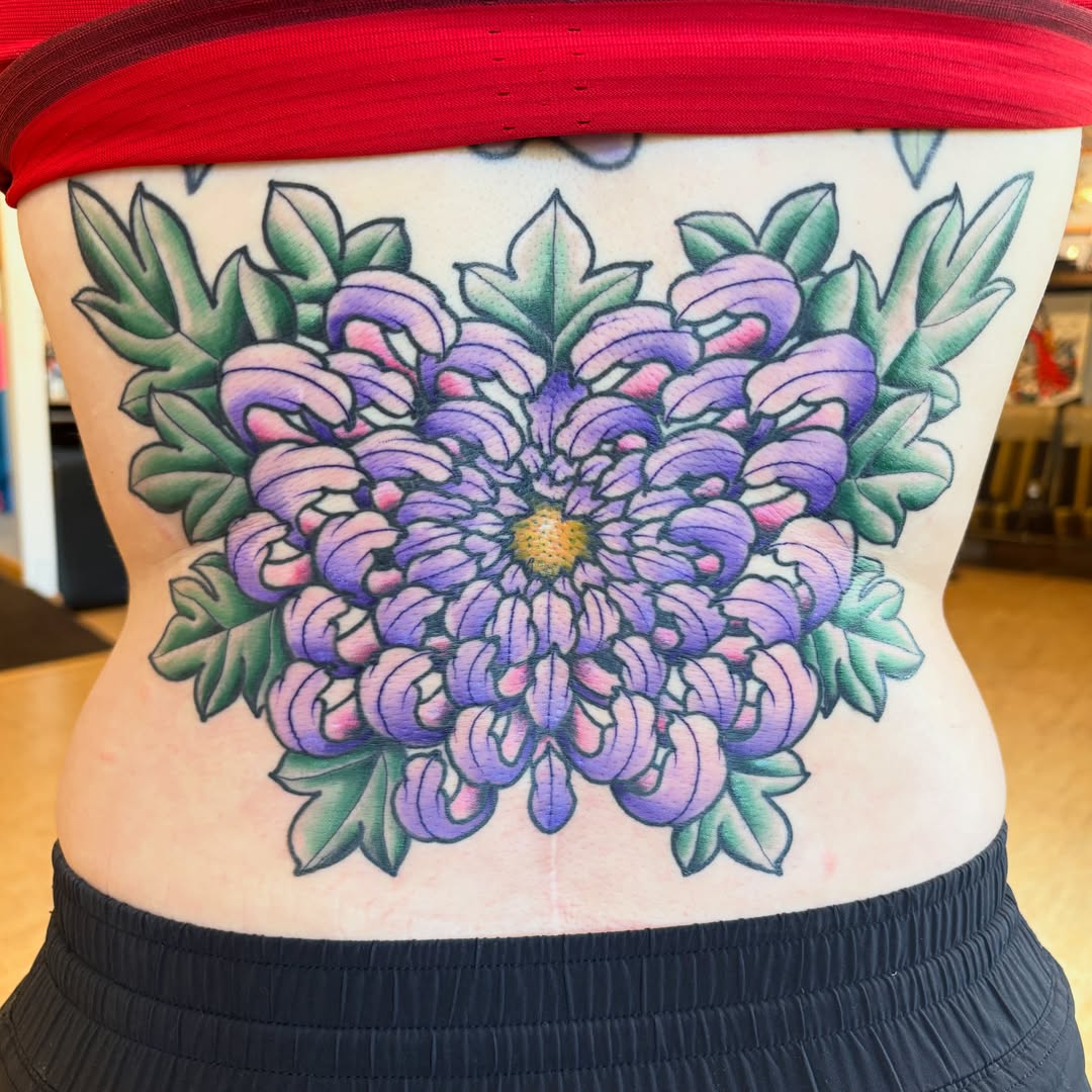 Purple flower American traditional tattoo on the torso by Kimber Teatro, Portland, Oregon