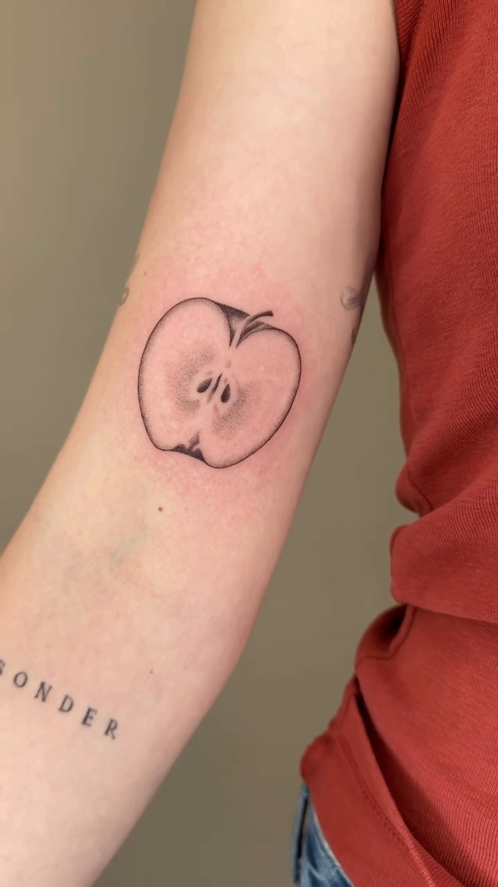 Apple fine line tattoo by Monica Reynolds