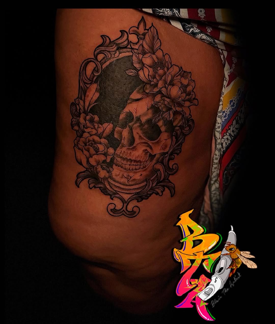 Skull with flowers in a frame tattoo on the thigh by Blair The Artist!