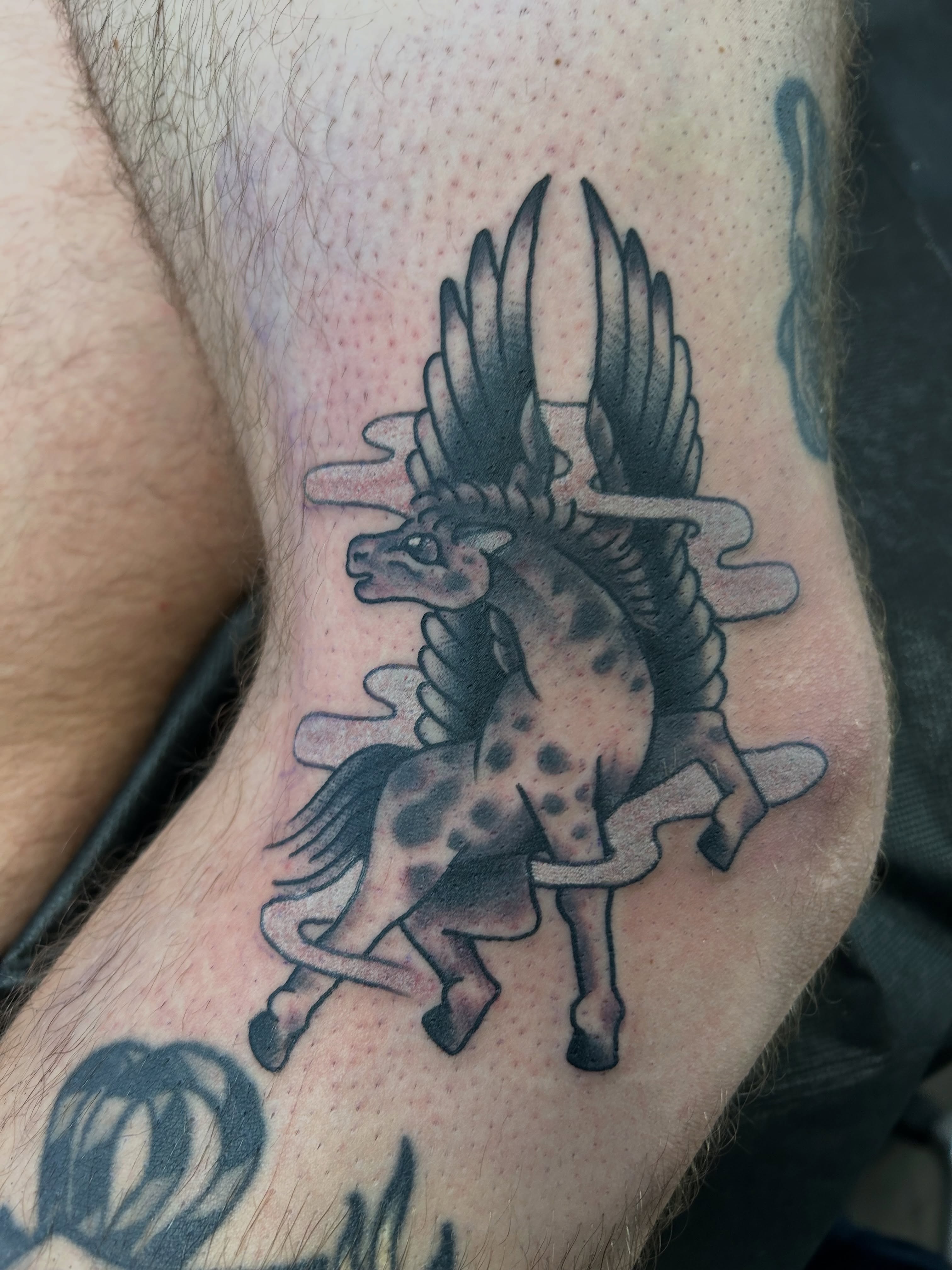 Winged unicorn black and grey tattoo on the forearm by Mike "Yogi" Trube