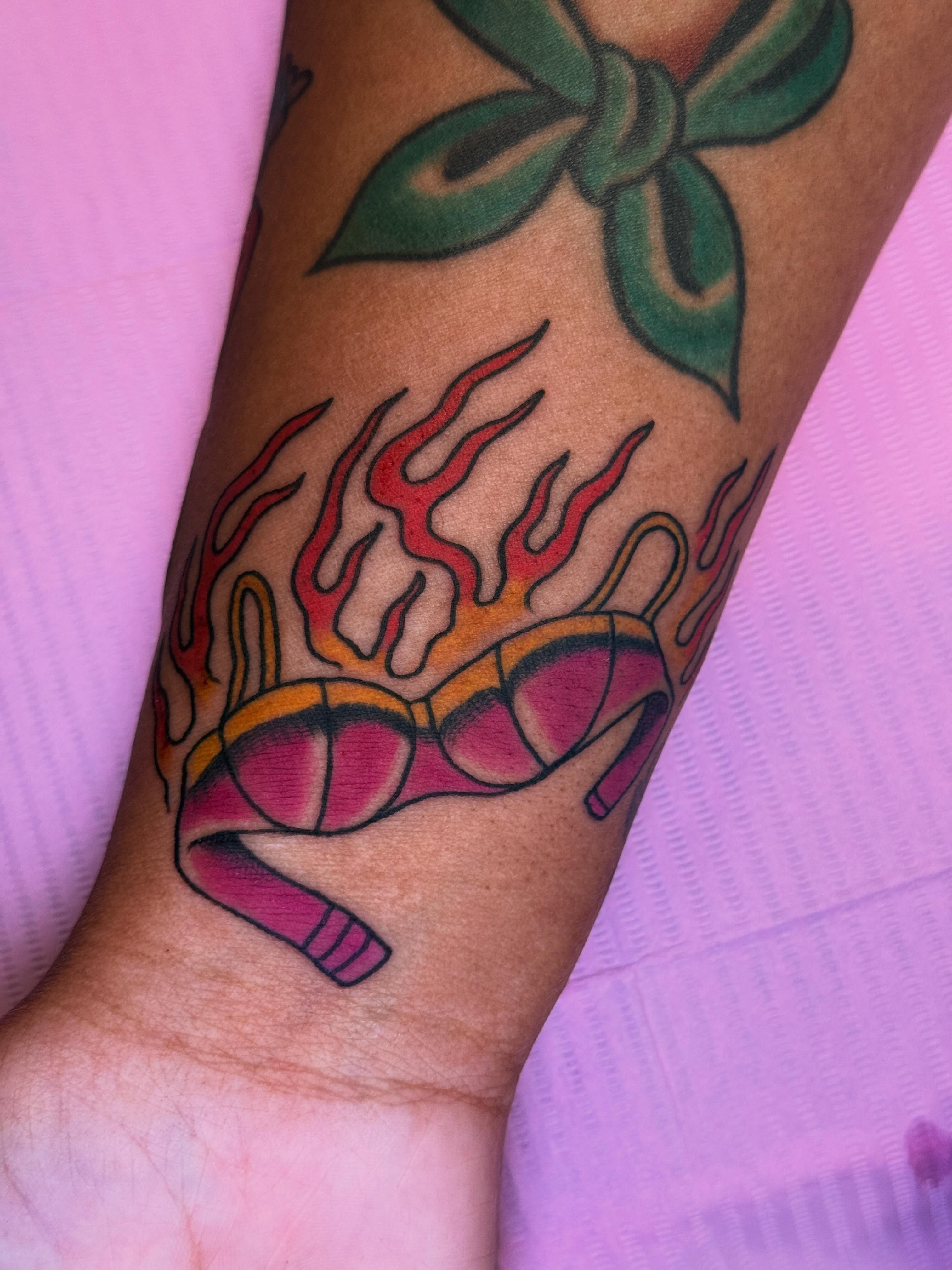 Flaming glasses American traditional tattoo on the forearm by Cassie O'Neal DeBord