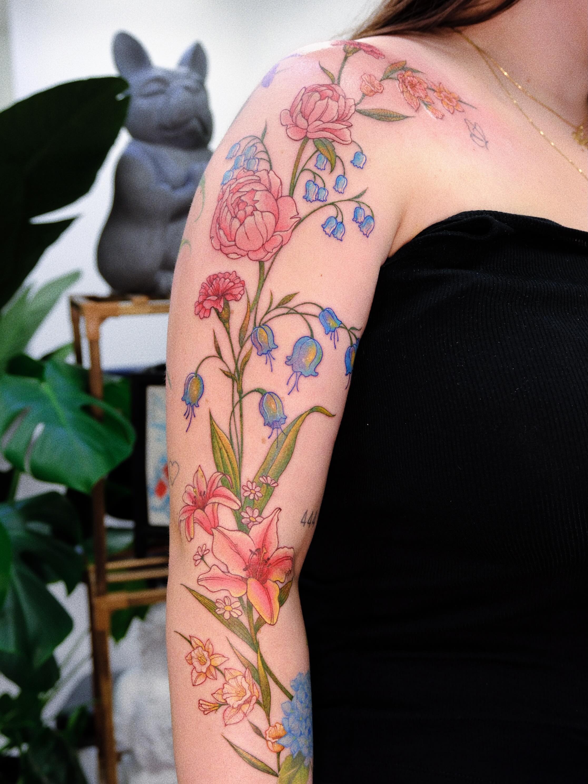 Floral arrangement realism tattoo on the upper arm by rita_tattooist