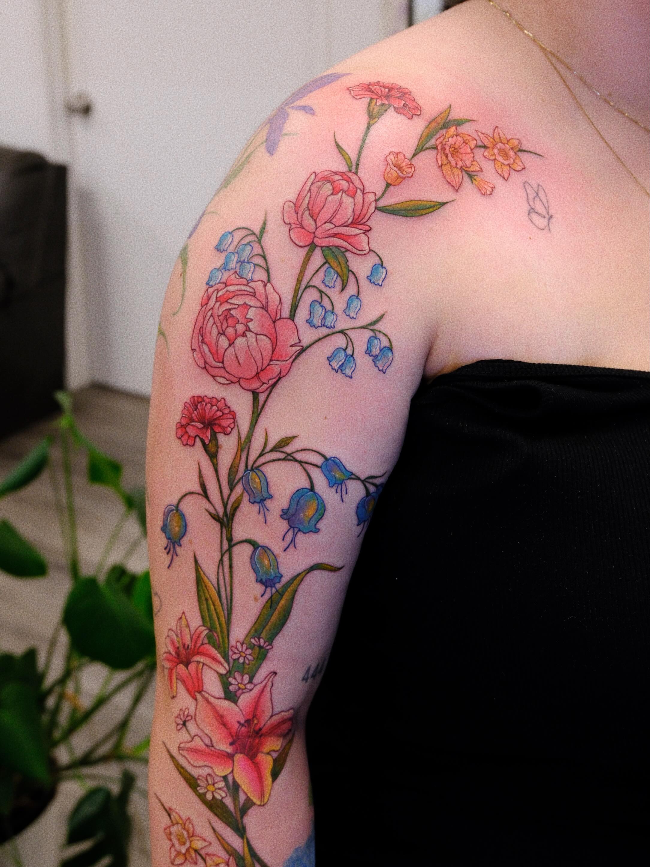 Floral arrangement new school tattoo on the shoulder by rita_tattooist