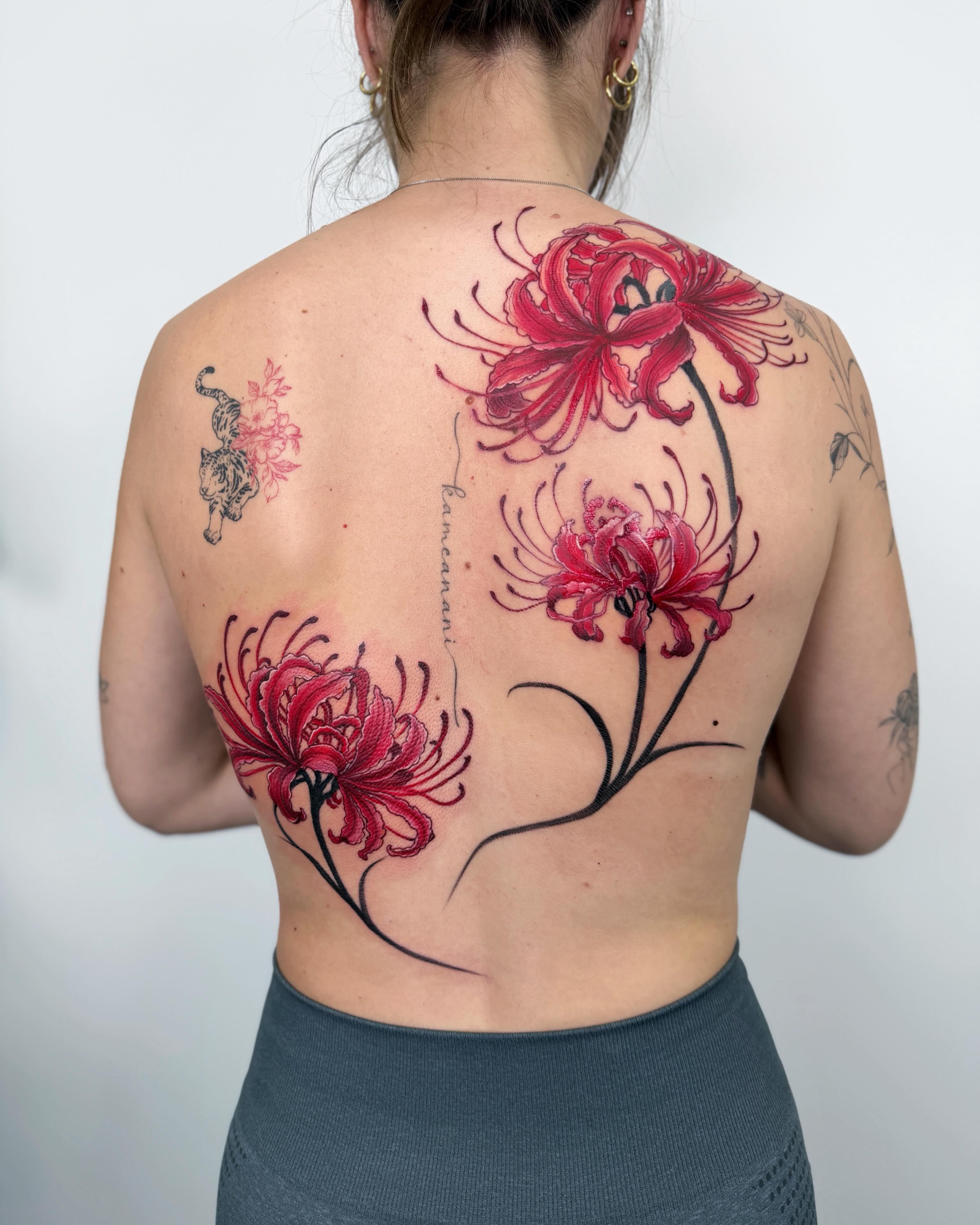 Red spider lilies realism tattoo on the back by Jiang_Tattooer