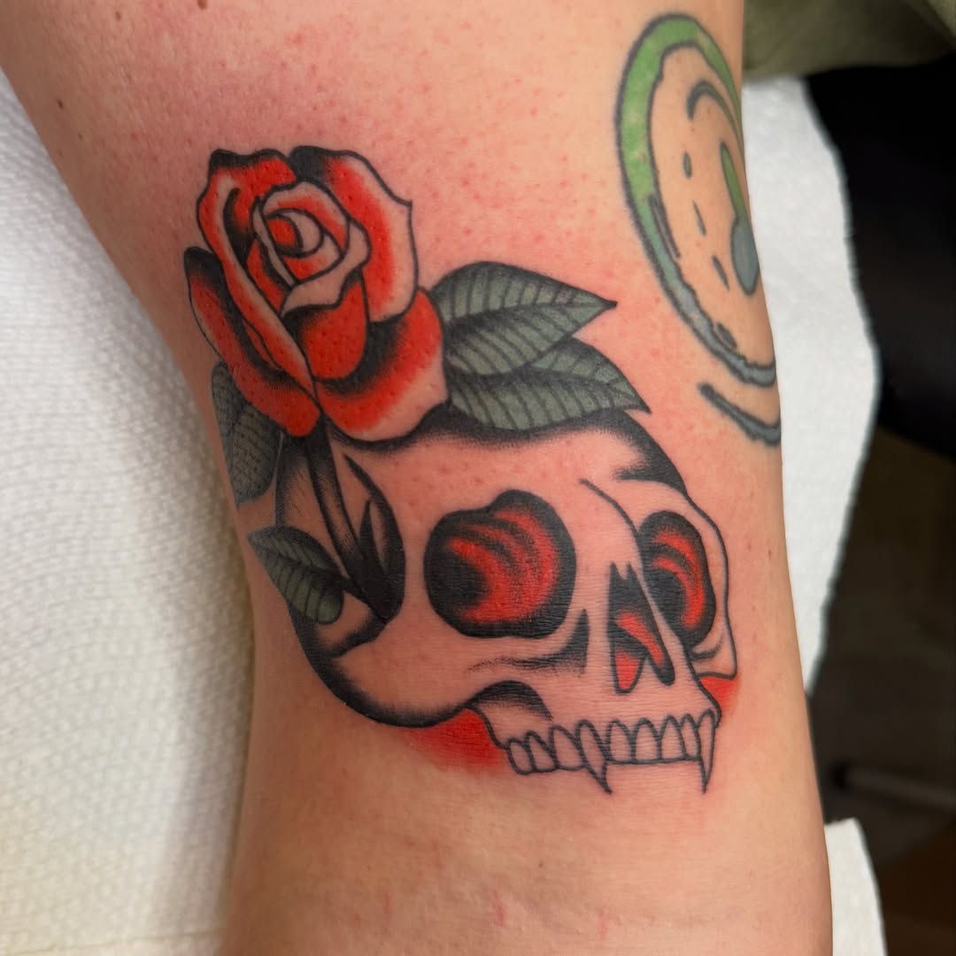 Skull and rose American traditional tattoo on the forearm by Allie Barringer