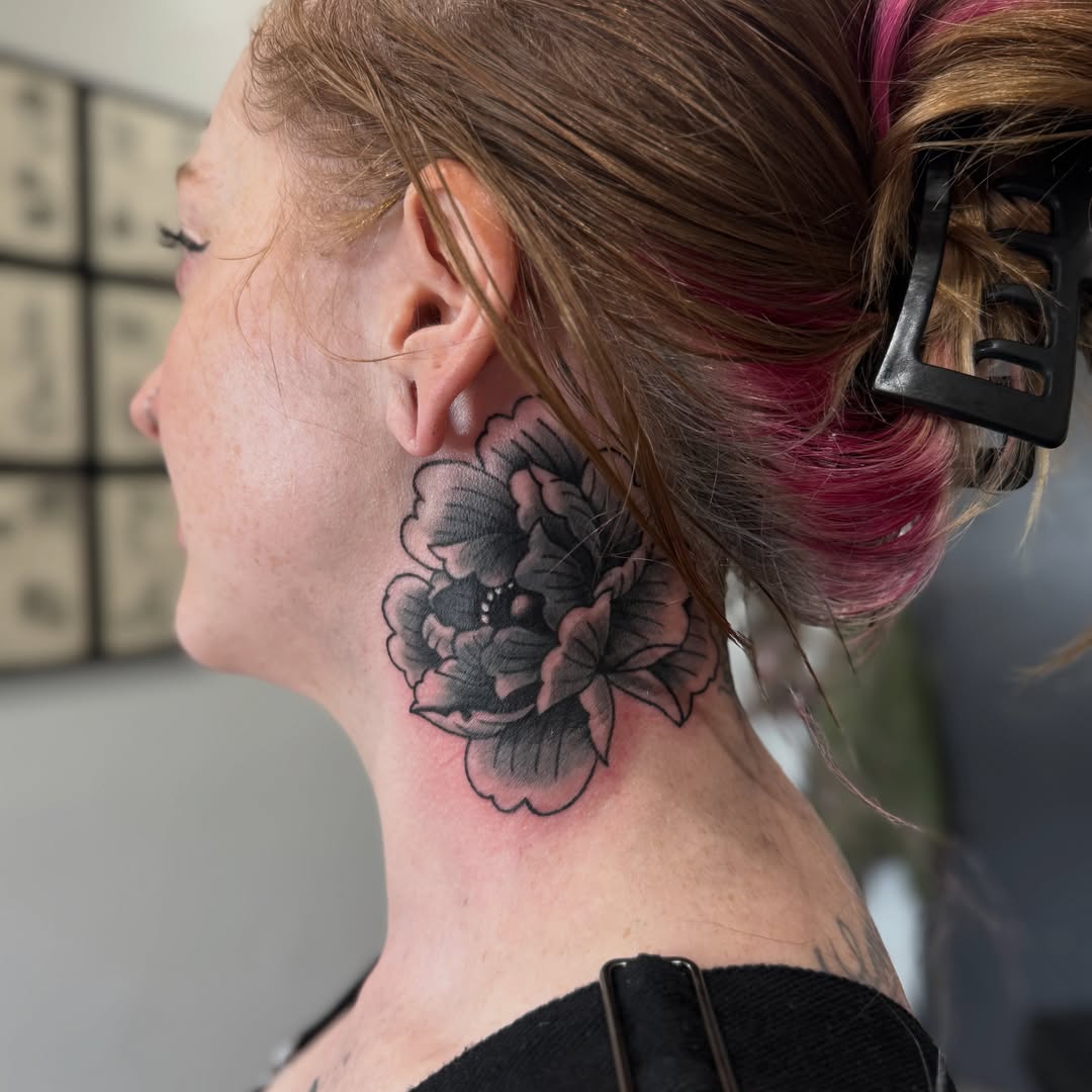 Flower black and grey tattoo on the neck by Allie Barringer