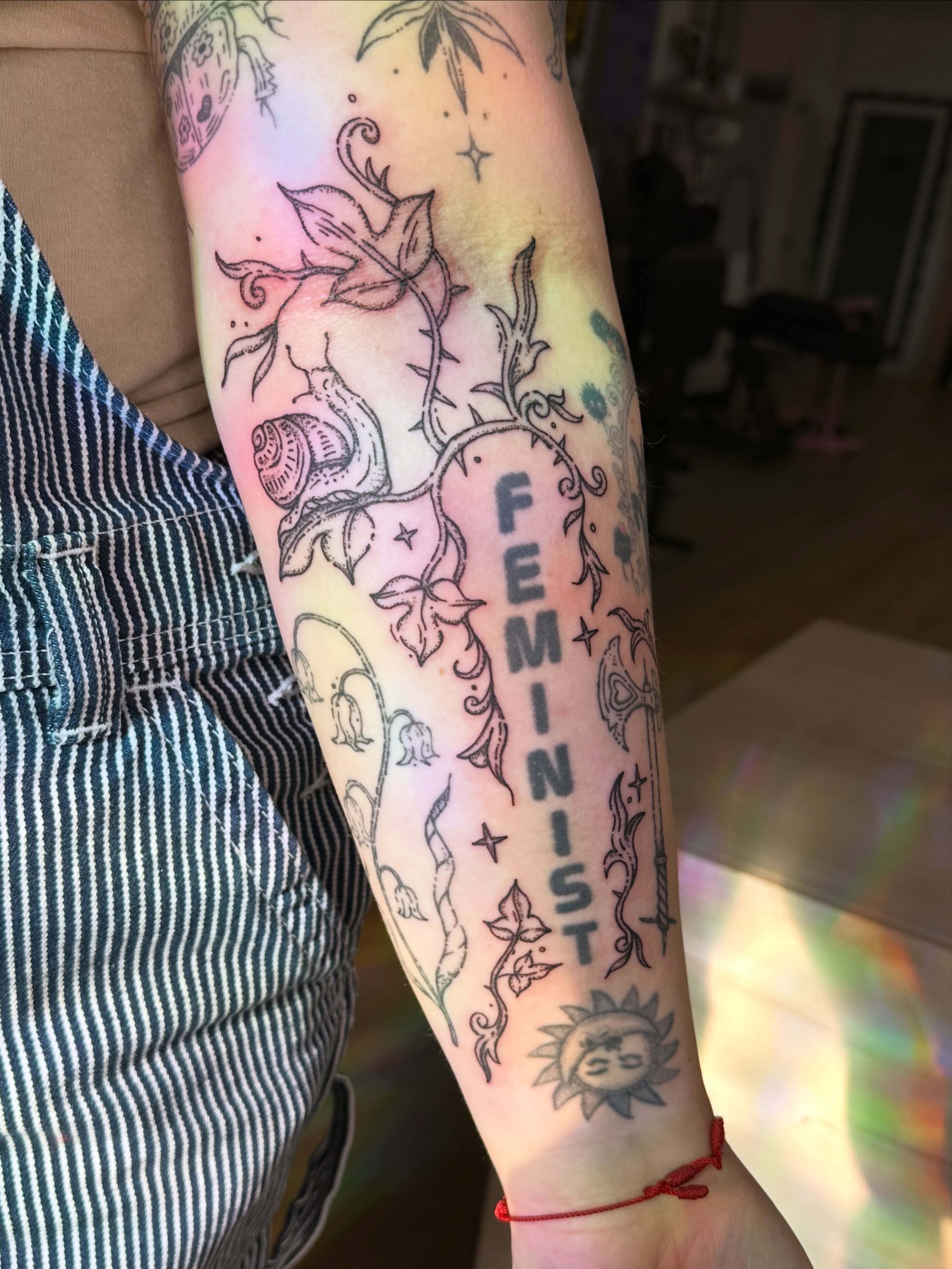 Feminist fine line tattoo on the forearm by Fleur ๐ฅ