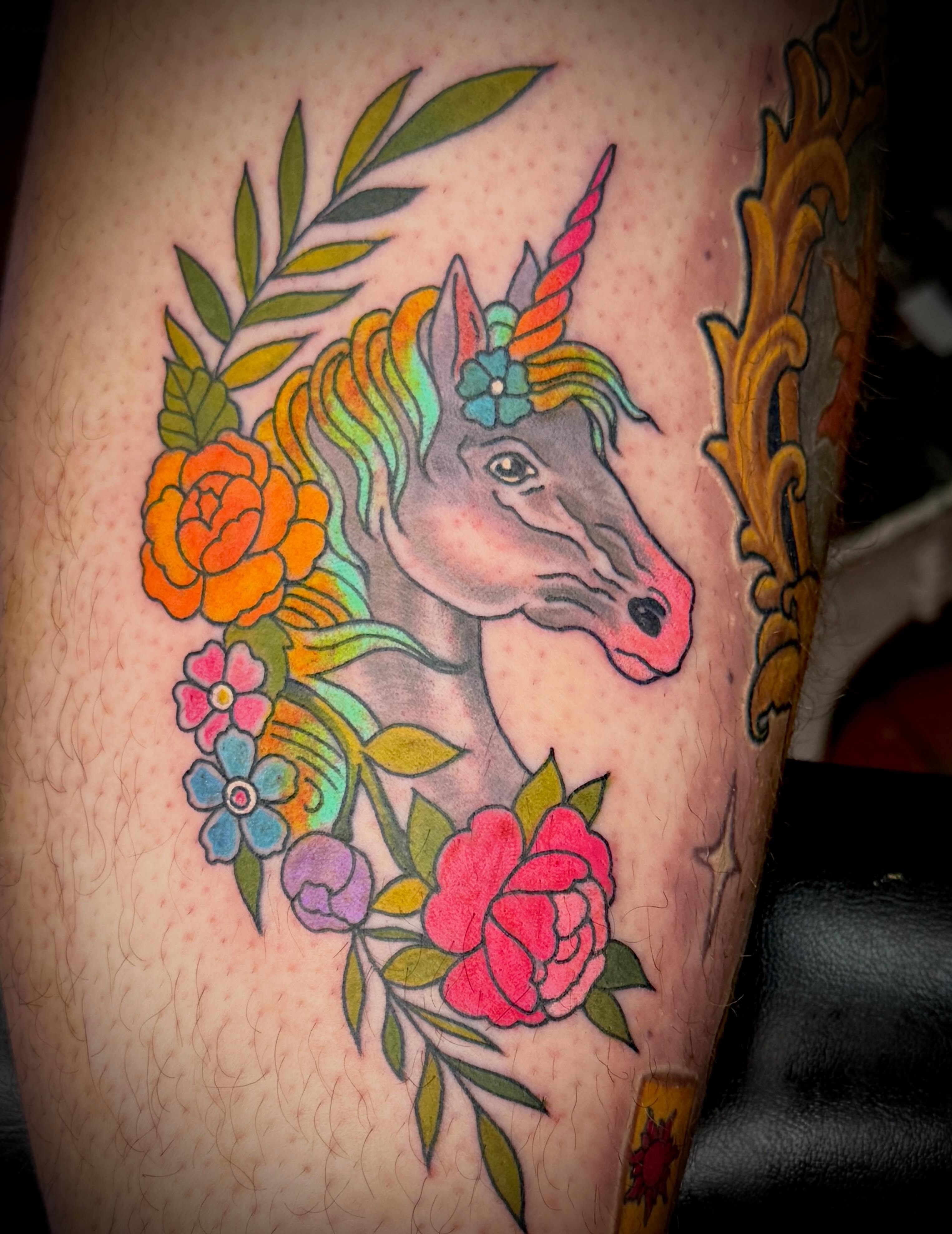 Unicorn and floral new school tattoo on the forearm by Hayden Abernathy