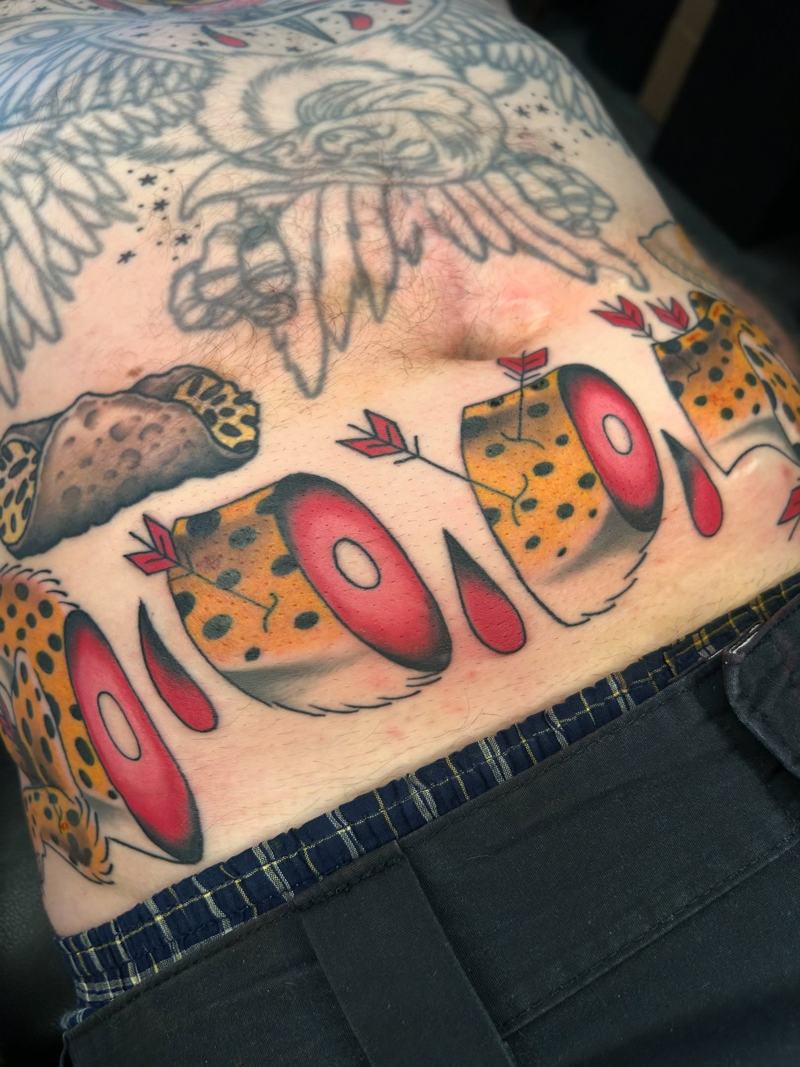 Cheetah and arrow American traditional tattoo on the thigh by Audrey Migitsch