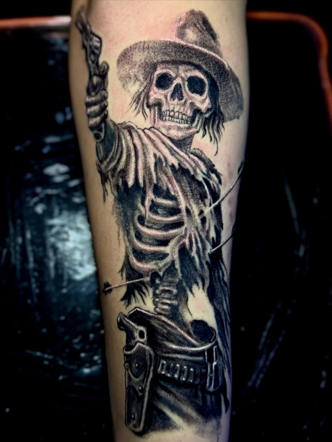 Skeleton cowboy with gun realism tattoo on the forearm by Jarrod Gatzke